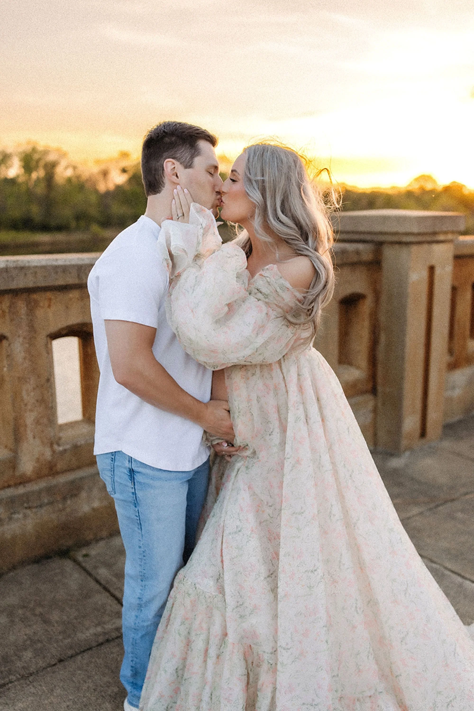 Golden hour Maternity Photos in Central Indiana featuring an expecting couple sharing a sunset kiss in a dreamy outdoor setting