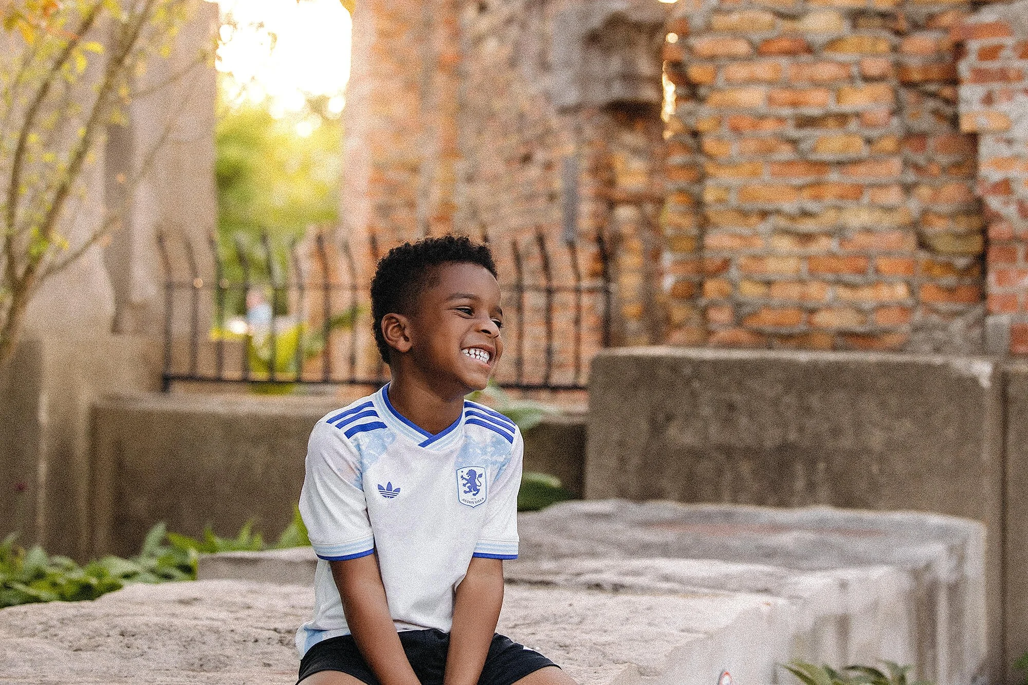 Little boy smiling at the camera during a spring mini session.