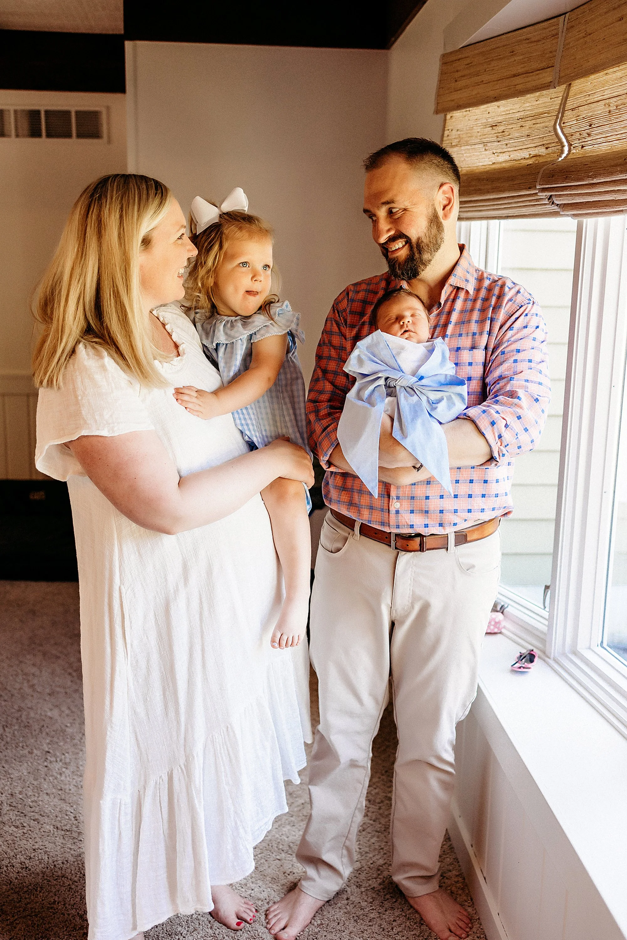 Toddler meeting new baby brother during Carmel newborn session