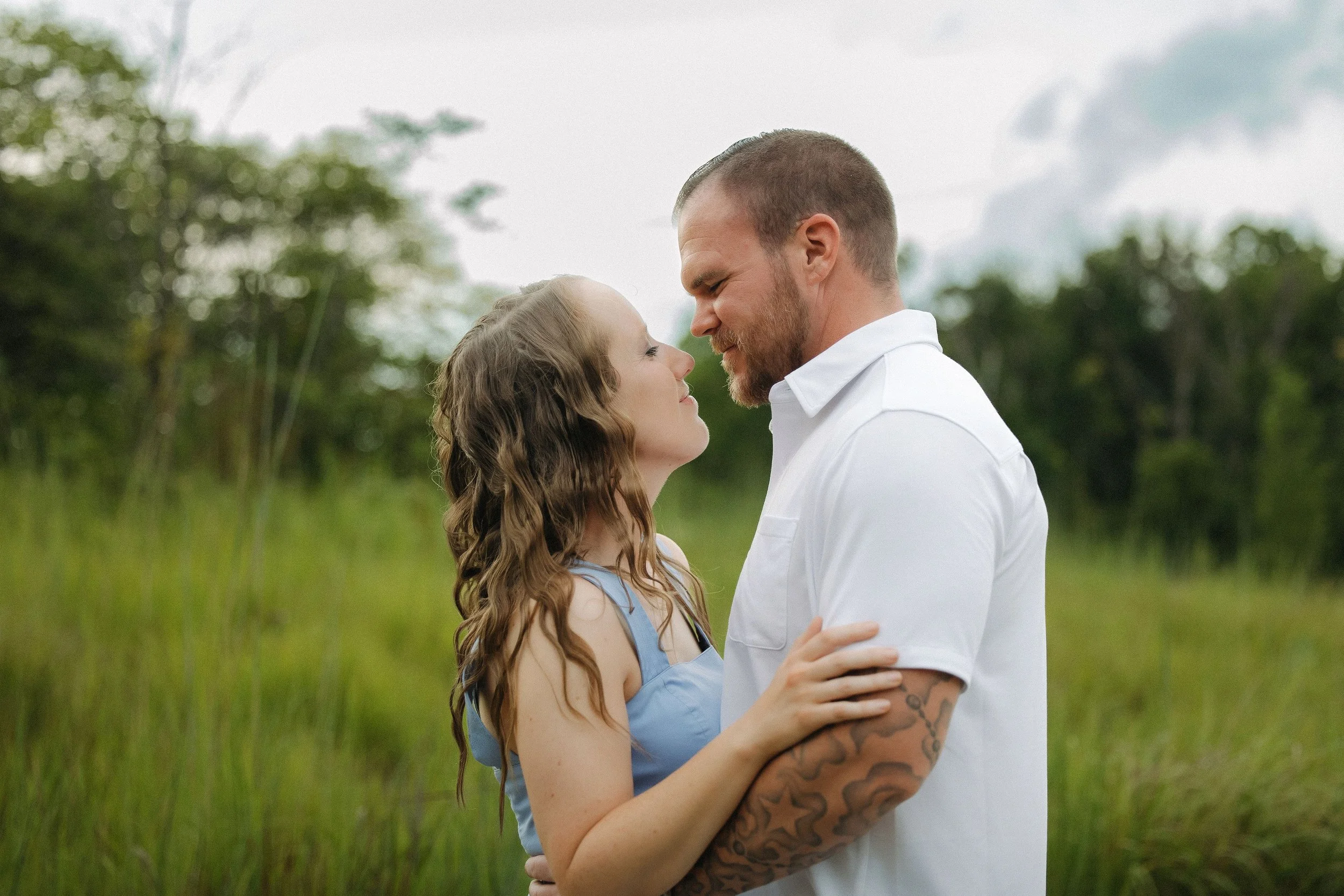 Photos of a couple surrounded by lush greenery in the woods, capturing a romantic and intimate moment