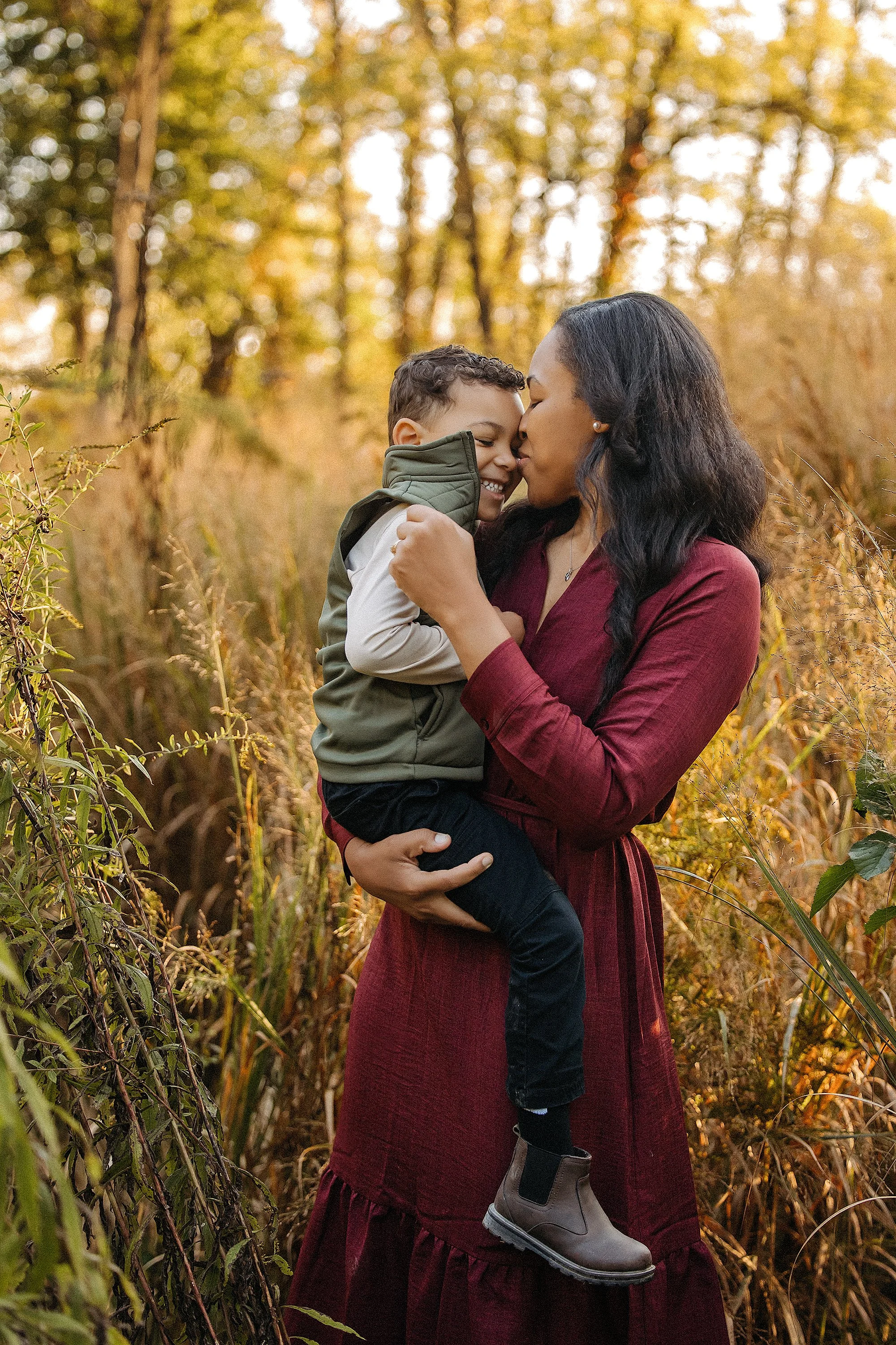 mother kisses son at 100 acre park in during indianapolis family photos