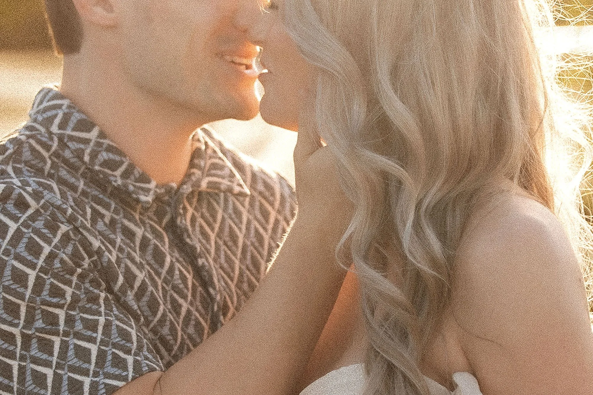 Expectant parents share a tender kiss in warm golden light during an intimate session of Maternity Photos in Central Indiana