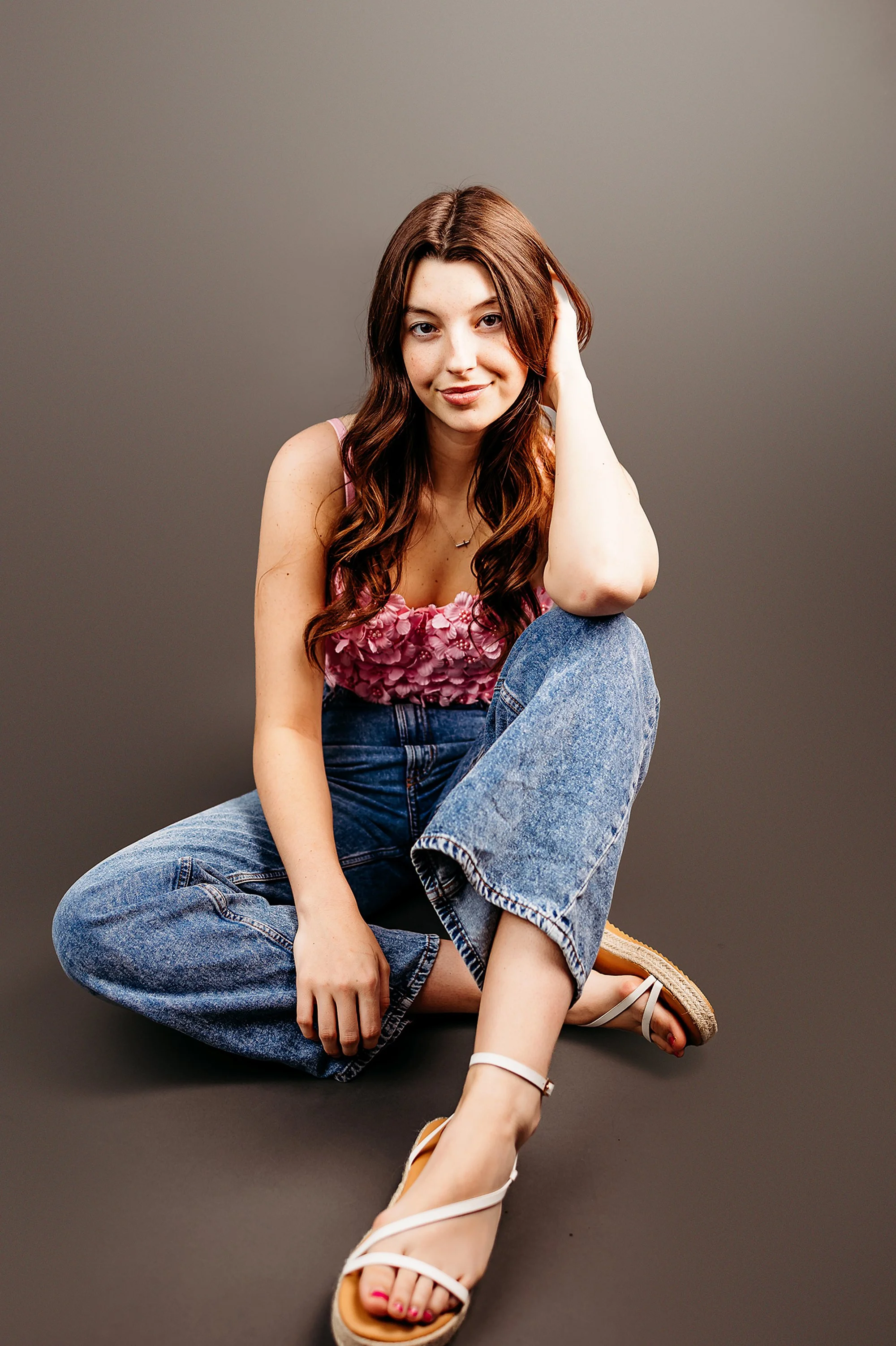 Studio Senior Portraits in Indianapolis with natural smile and soft minimalist background
