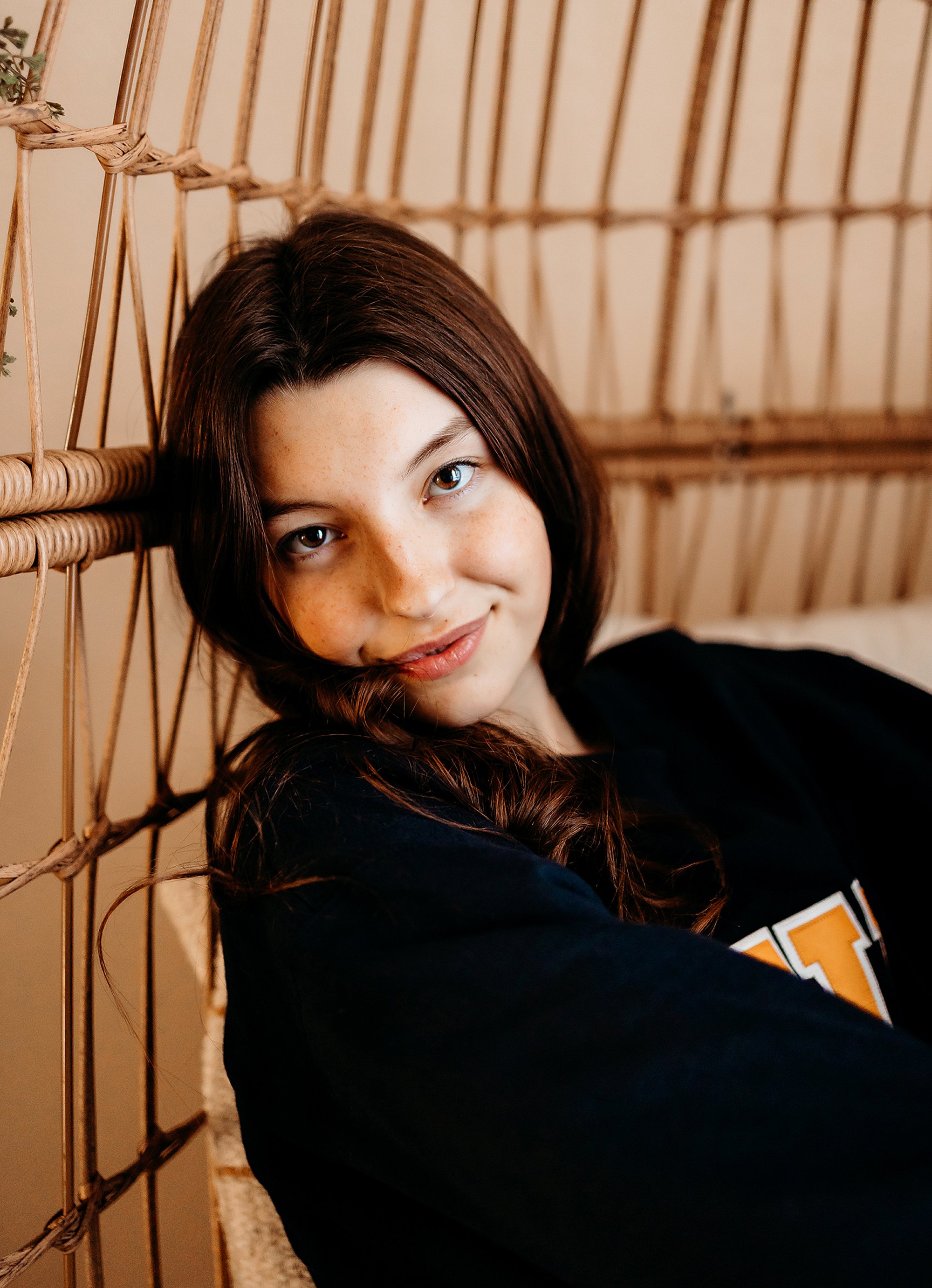 Modern indoor senior portrait in Central Indiana with clean editorial lighting and warm backdrop