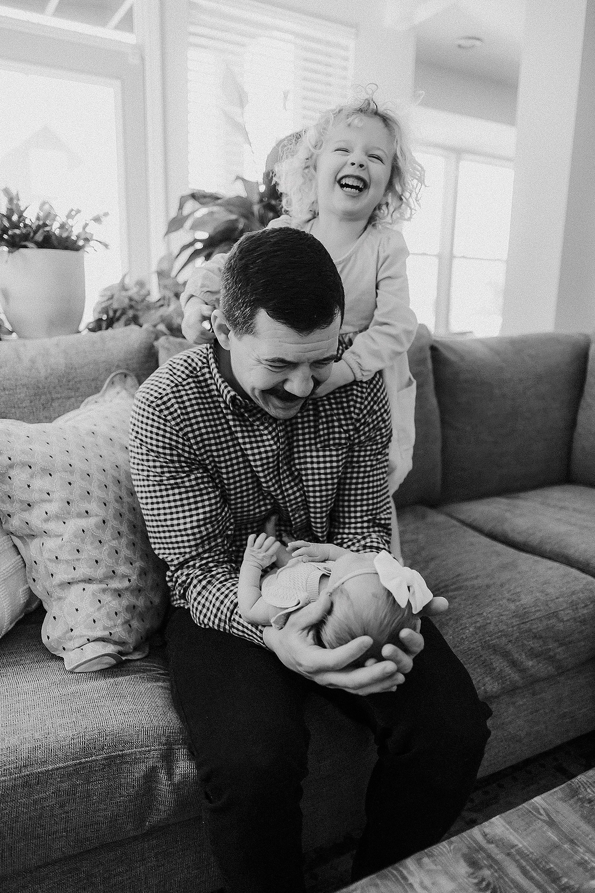 Dad in simple neutral clothing during an in-home newborn session