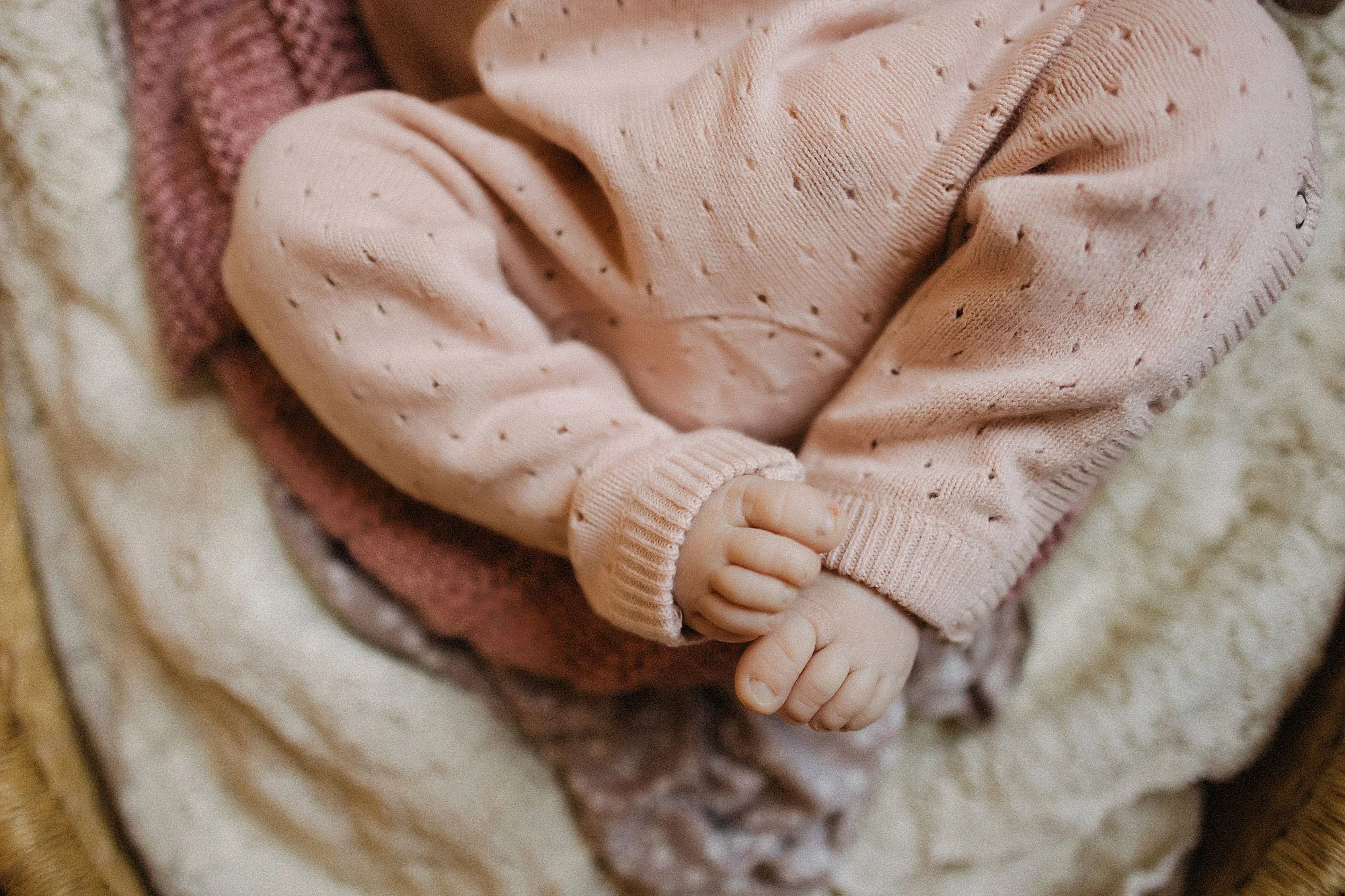 newborn baby detail photo of tiny hands and feet