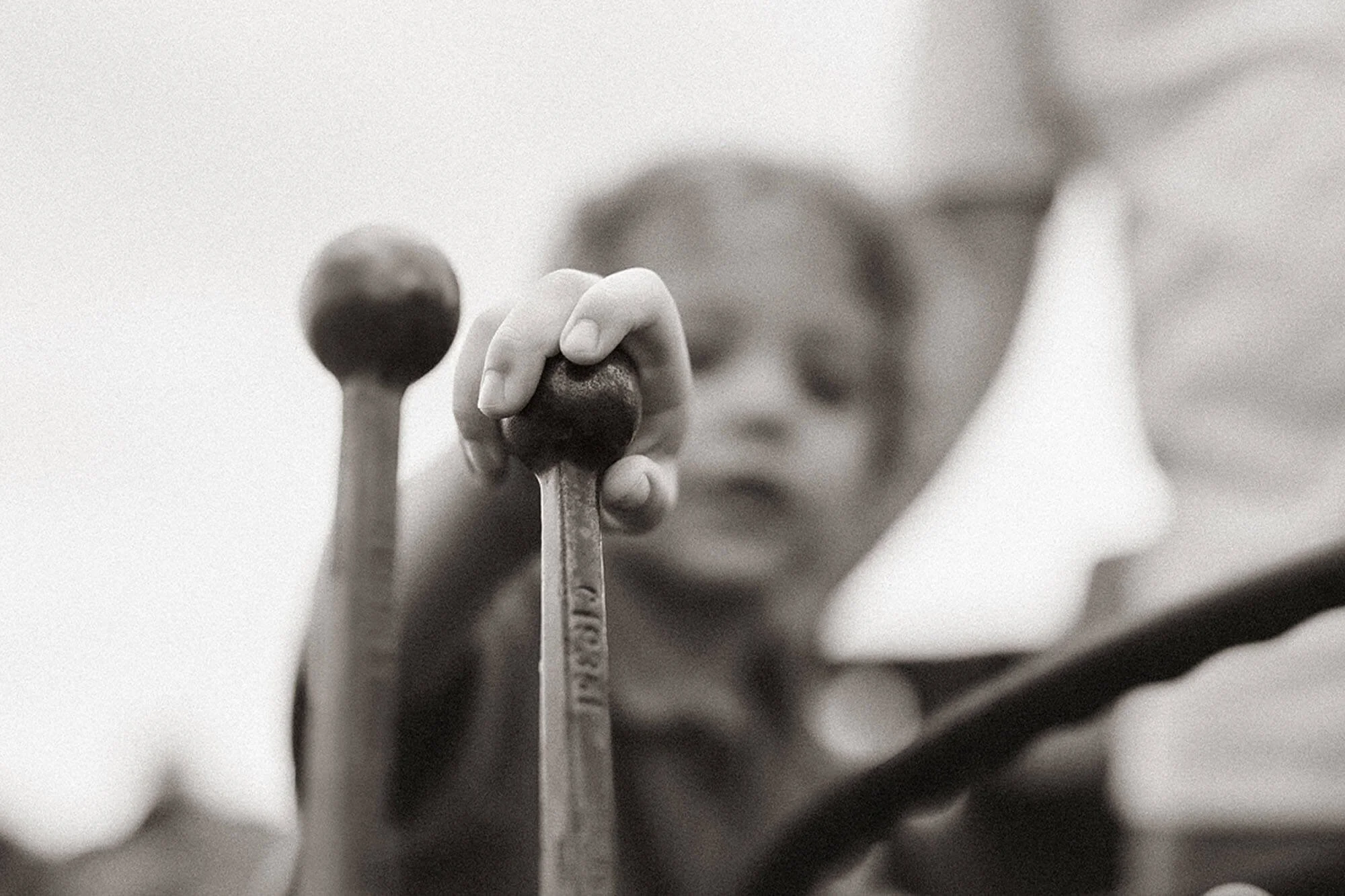 Close-up black and white portrait at Heavenly Acres Farm with a hand resting on a vintage golf club