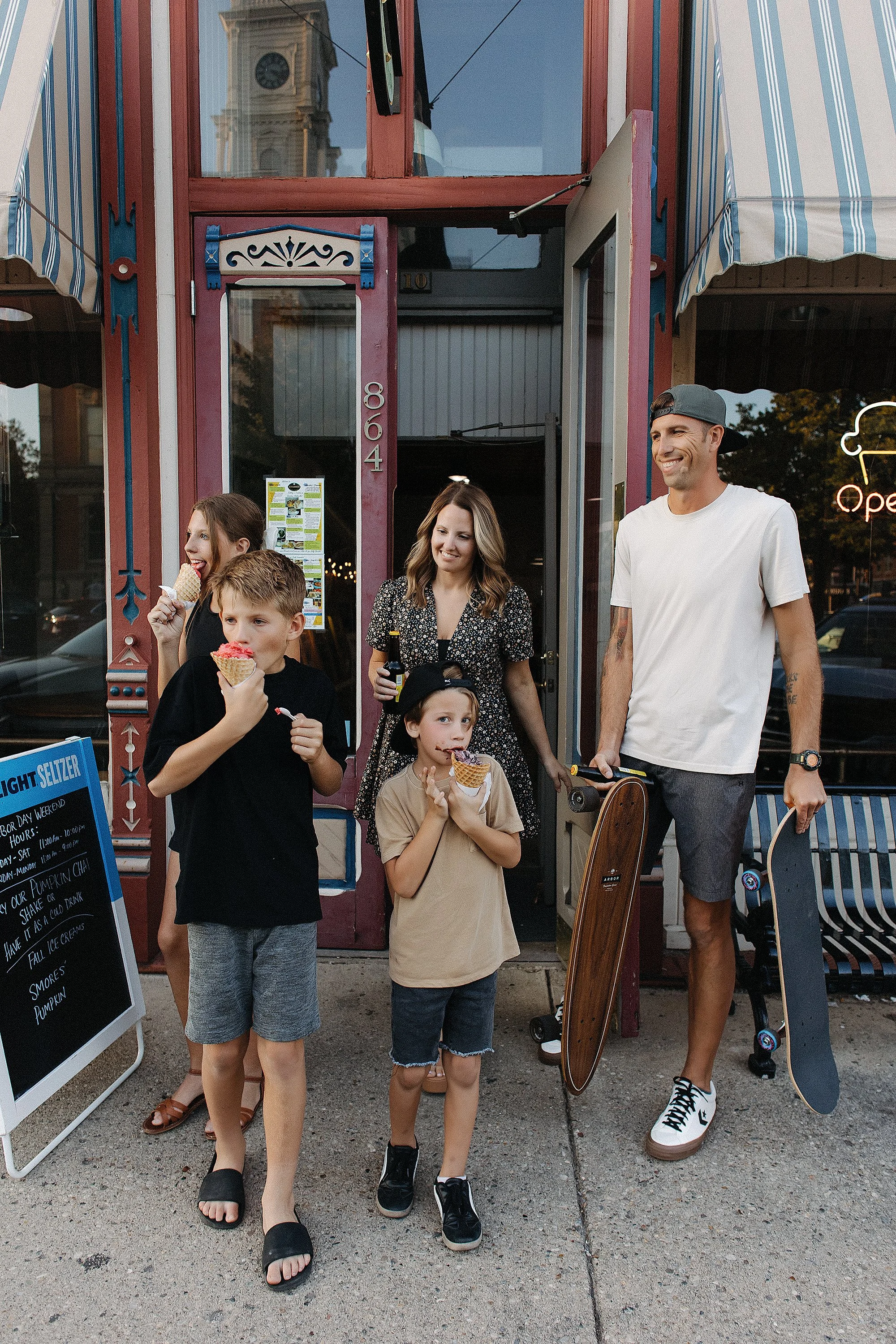 Fun outdoor family moment with ice cream, skateboards, and genuine smiles, ideal for family photo session ideas
