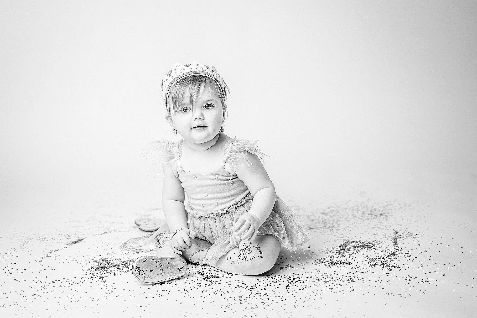toddler sitting in studio during glitter mini birthday session