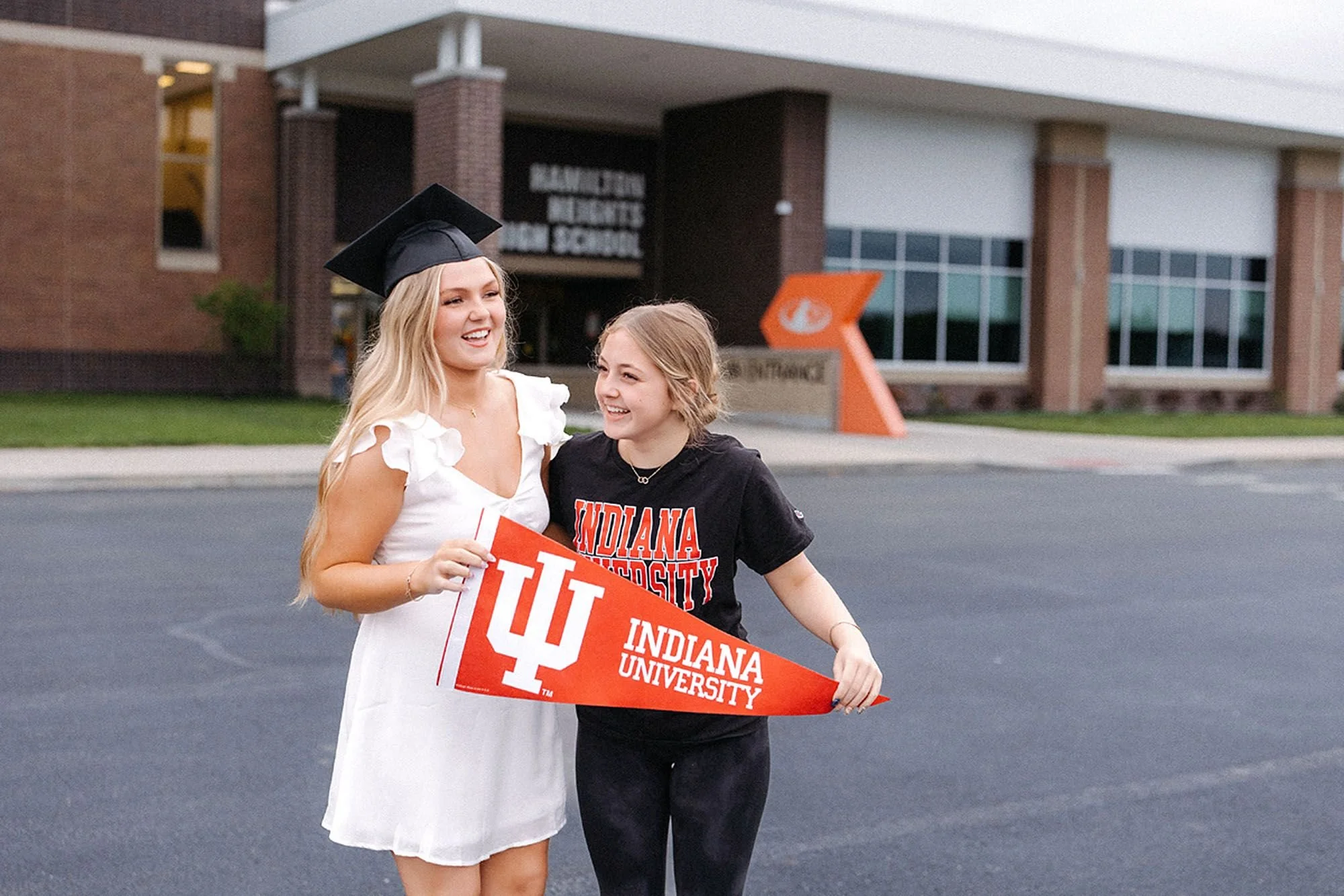 Joyful Hamilton Heights Senior Photos capturing a high school senior in a graduation cap alongside a sibling while celebrating the next chapter at Indiana University
