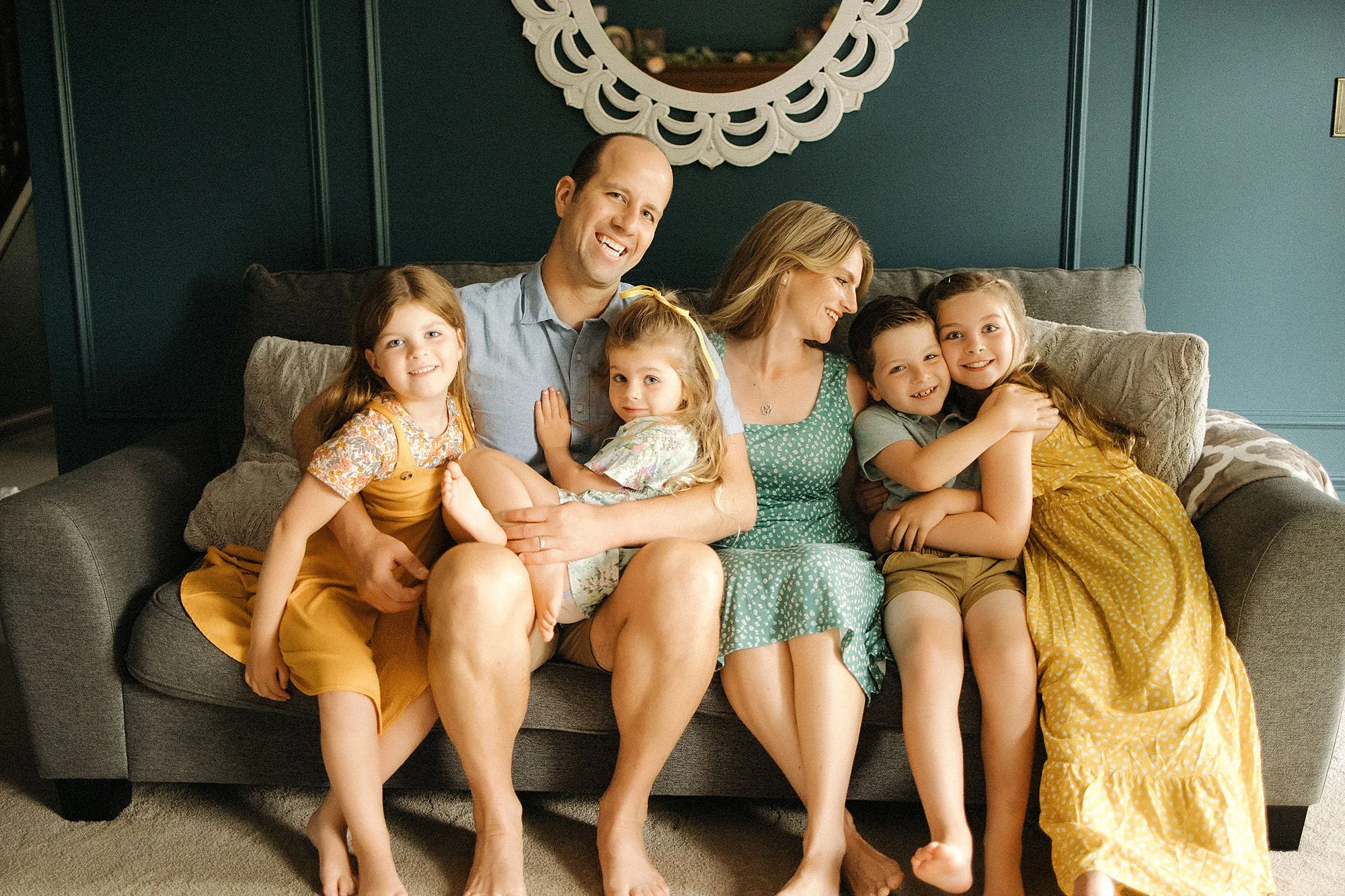 Stumpf family cuddled together on the couch during their in-home family session in Indianapolis.
