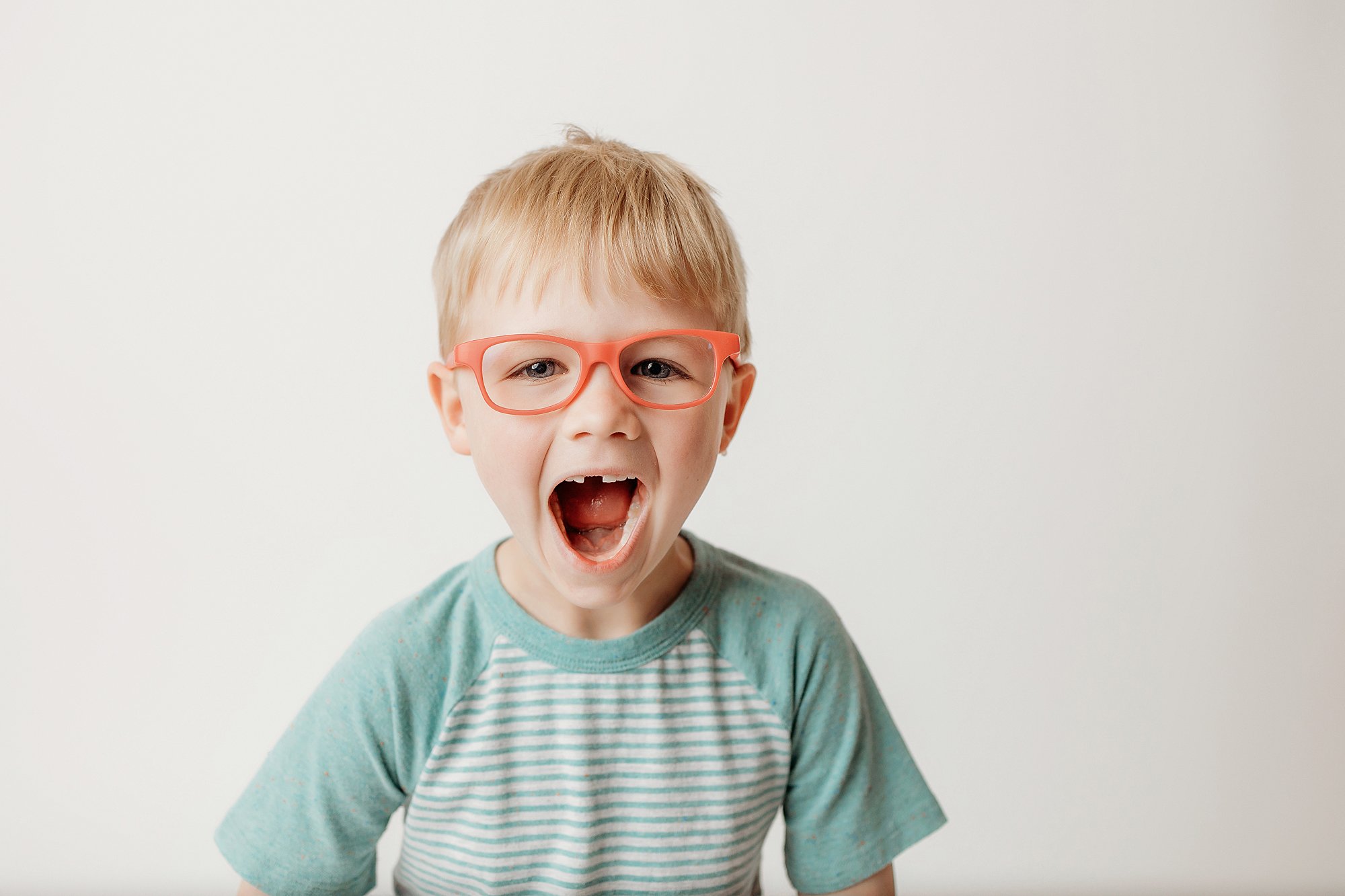 Studio portrait of a child showing their real personality on a simple white background