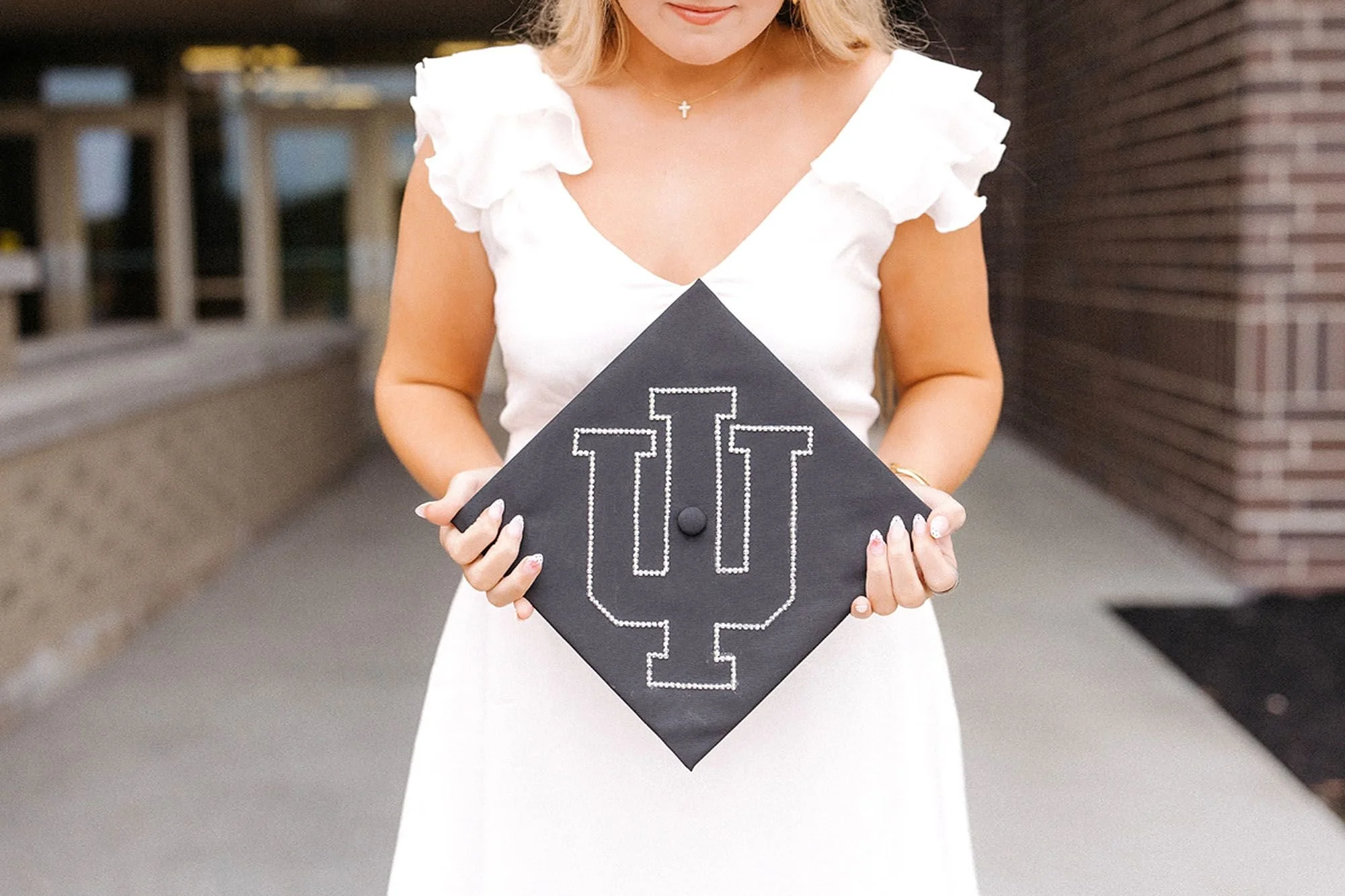 Hamilton Heights Senior Photos capturing a senior proudly displaying a handcrafted Indiana University graduation cap during a meaningful college reveal portrait