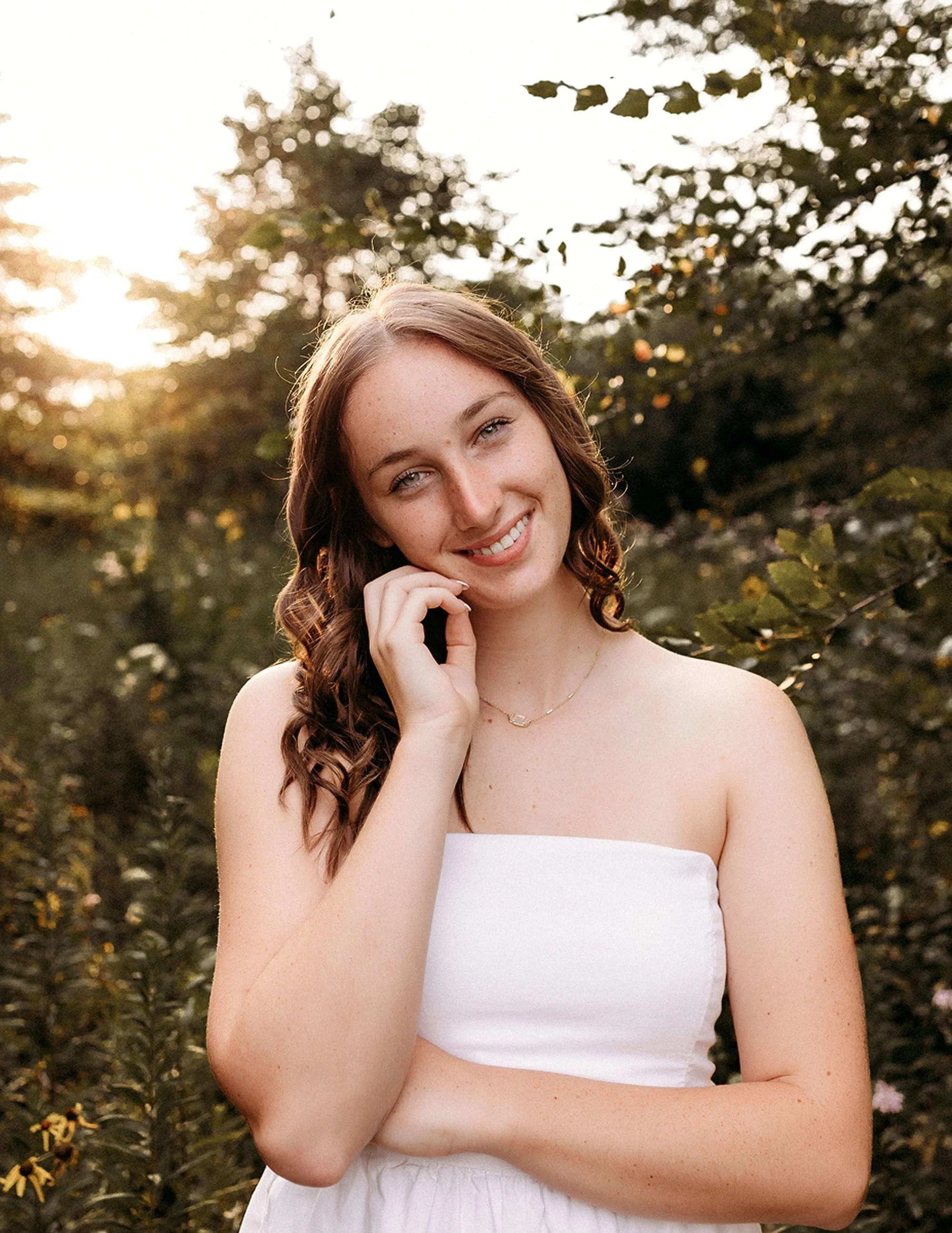 Natural outdoor portrait of a smiling high school senior at golden hour for timeless Sheridan High School Senior Photos.