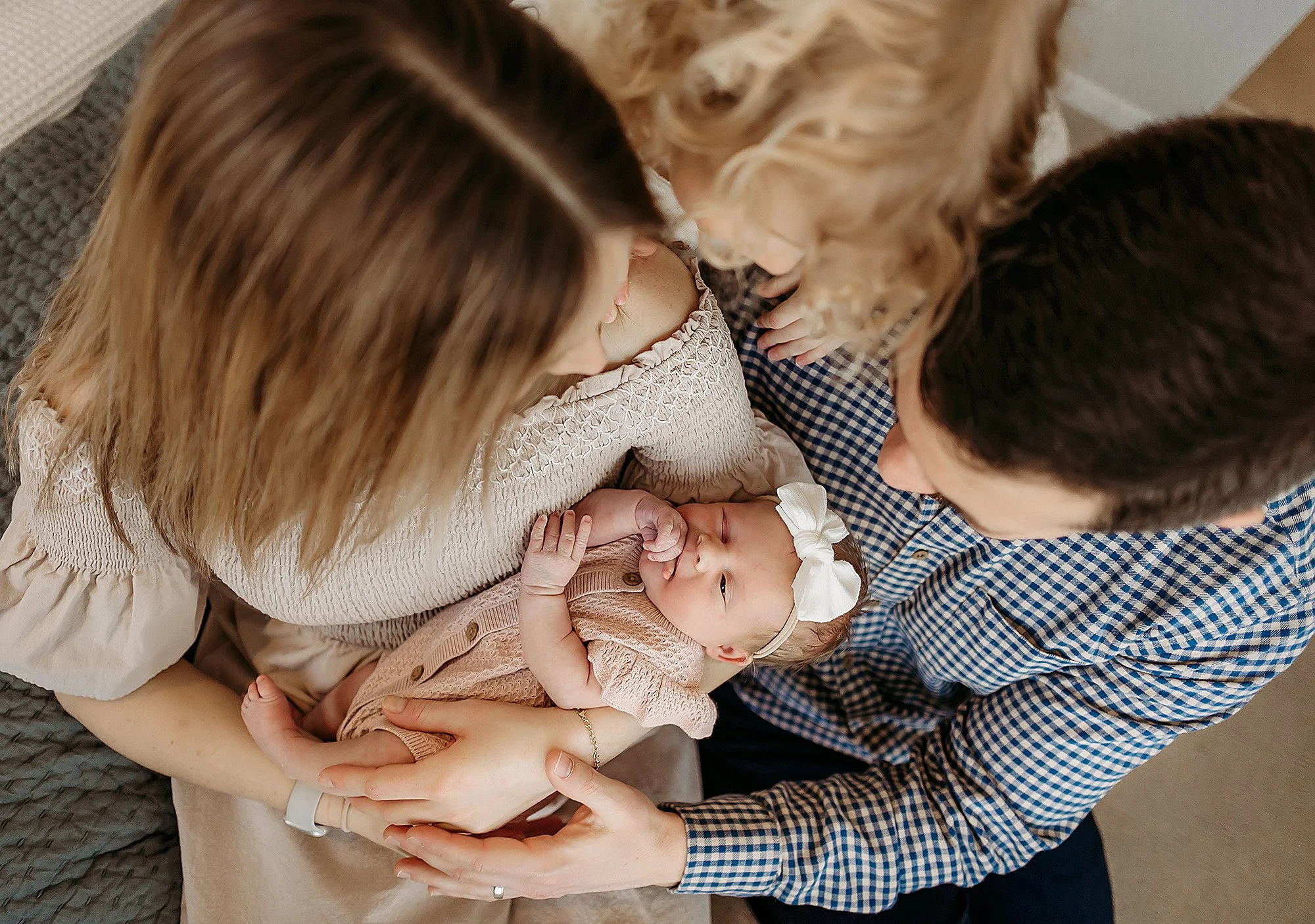 Coordinating outfits for parents and baby during newborn photos
