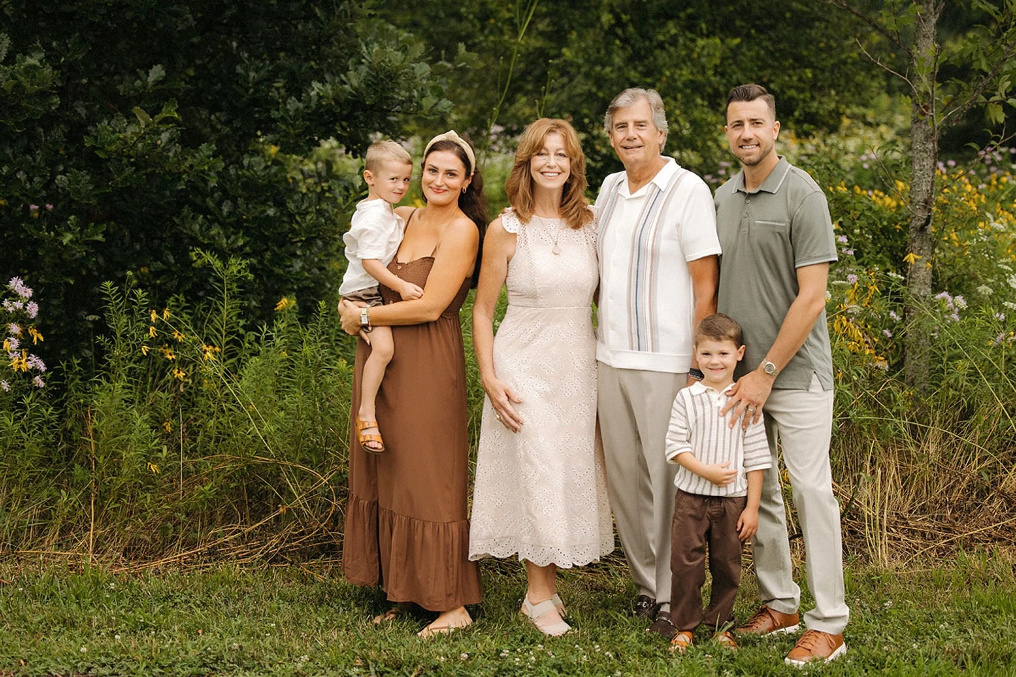 Parent and children standing together with their parents during a summer family photo session in Westfield, Indiana