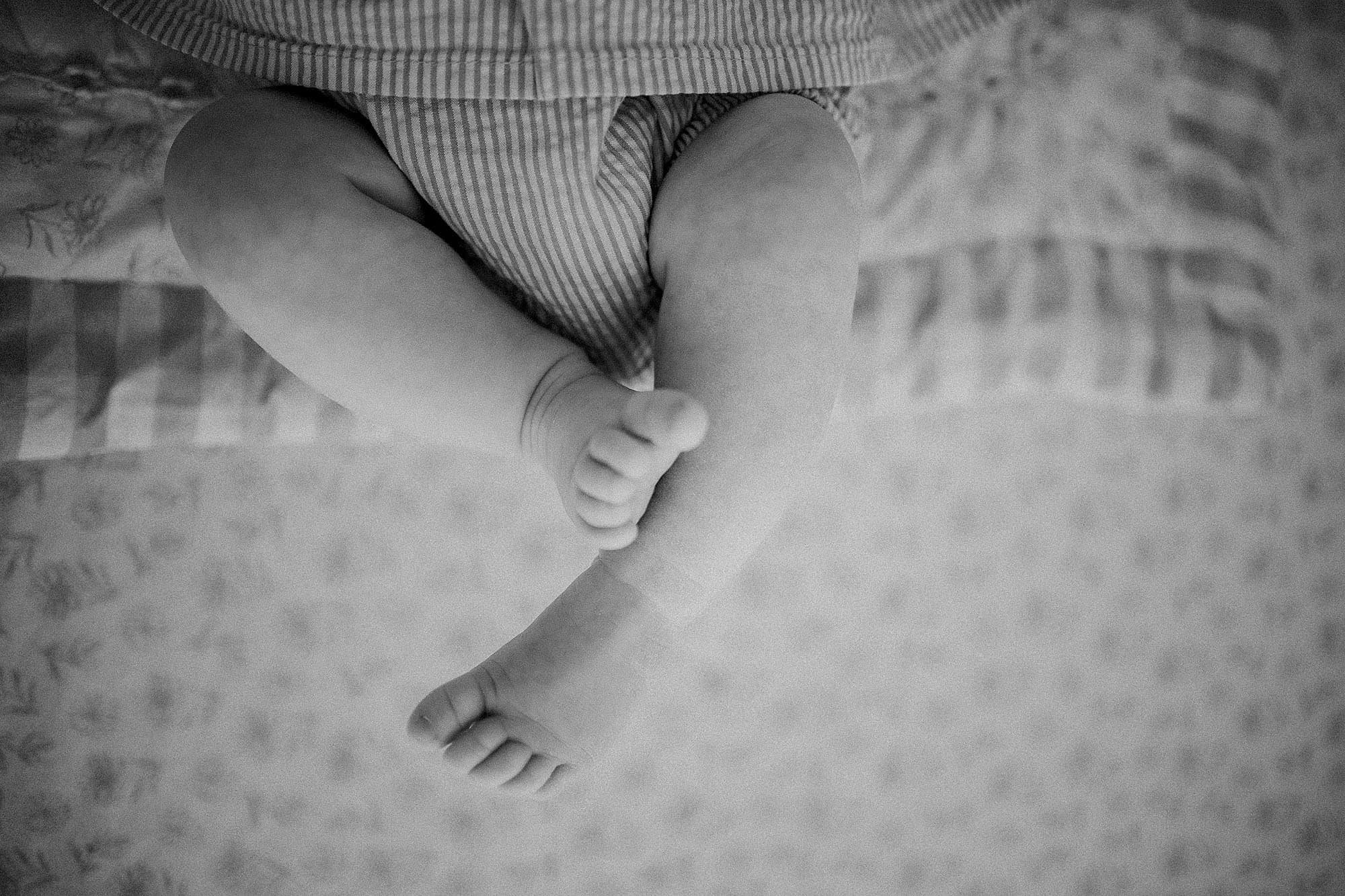 black and white newborn lifestyle photography detail of baby feet