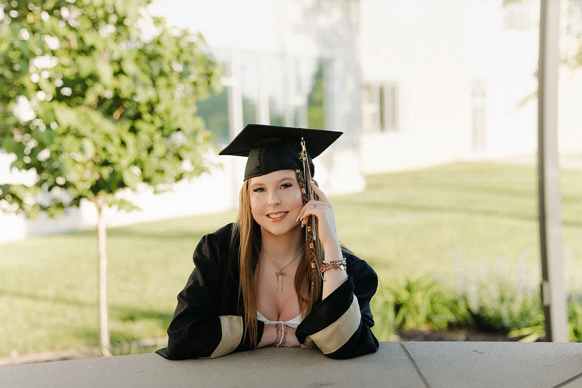 Professional Lebanon senior photos featuring a graduating senior in a black cap and gown smiling during an outdoor portrait session