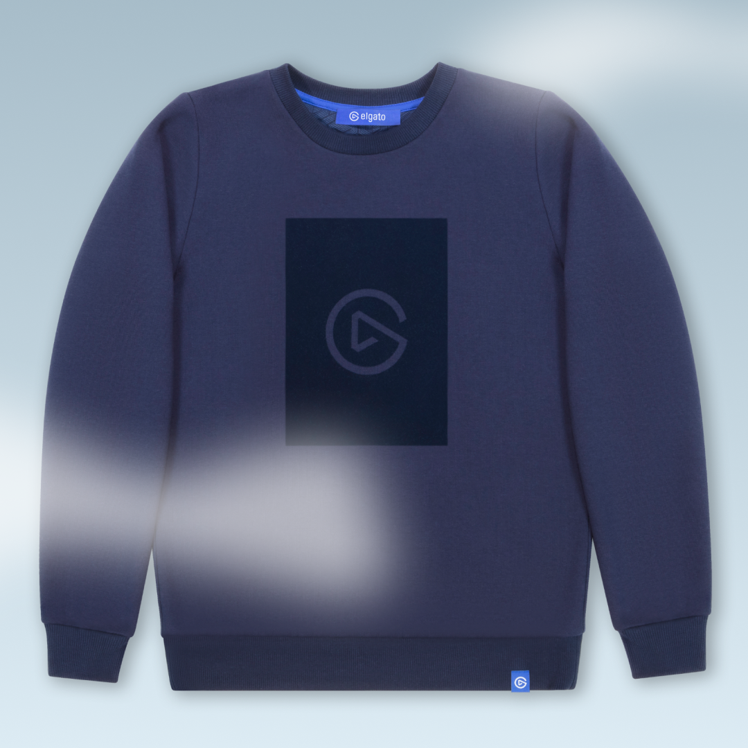 A navy blue sweatshirt with a rectangular black logo on the front and a small blue tag with a white logo at the bottom.