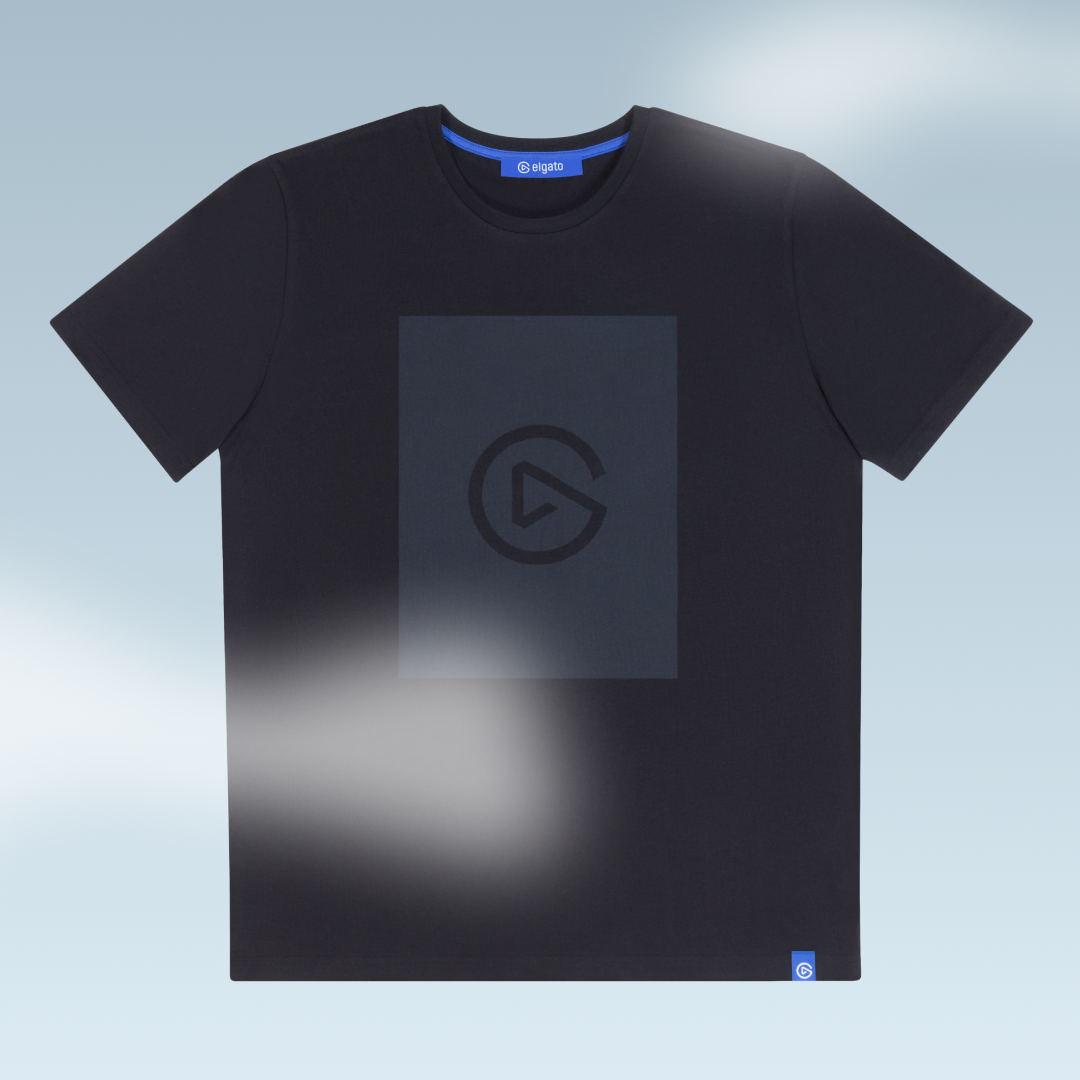 Black T-shirt with a minimalistic logo in the center and a small logo tag at the bottom right corner, displayed against a light blue background.