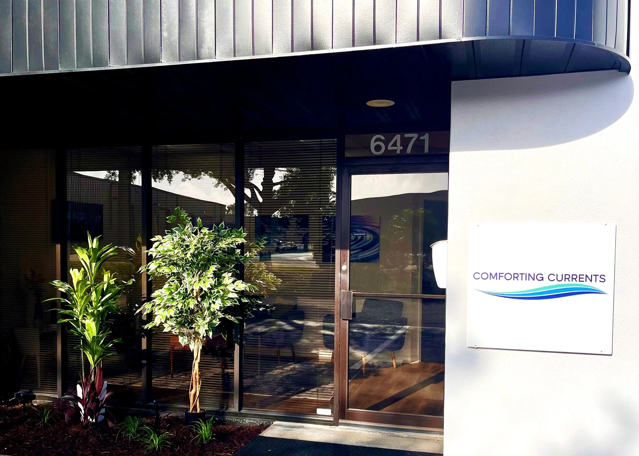 Exterior photo of entrance, signage and landscaping of our convenient location providing pet cremation and euthanasia for all of Manatee and Sarasota counties and adjoining areas at 6471 Parkland Drive in a safe, well maintained location.
