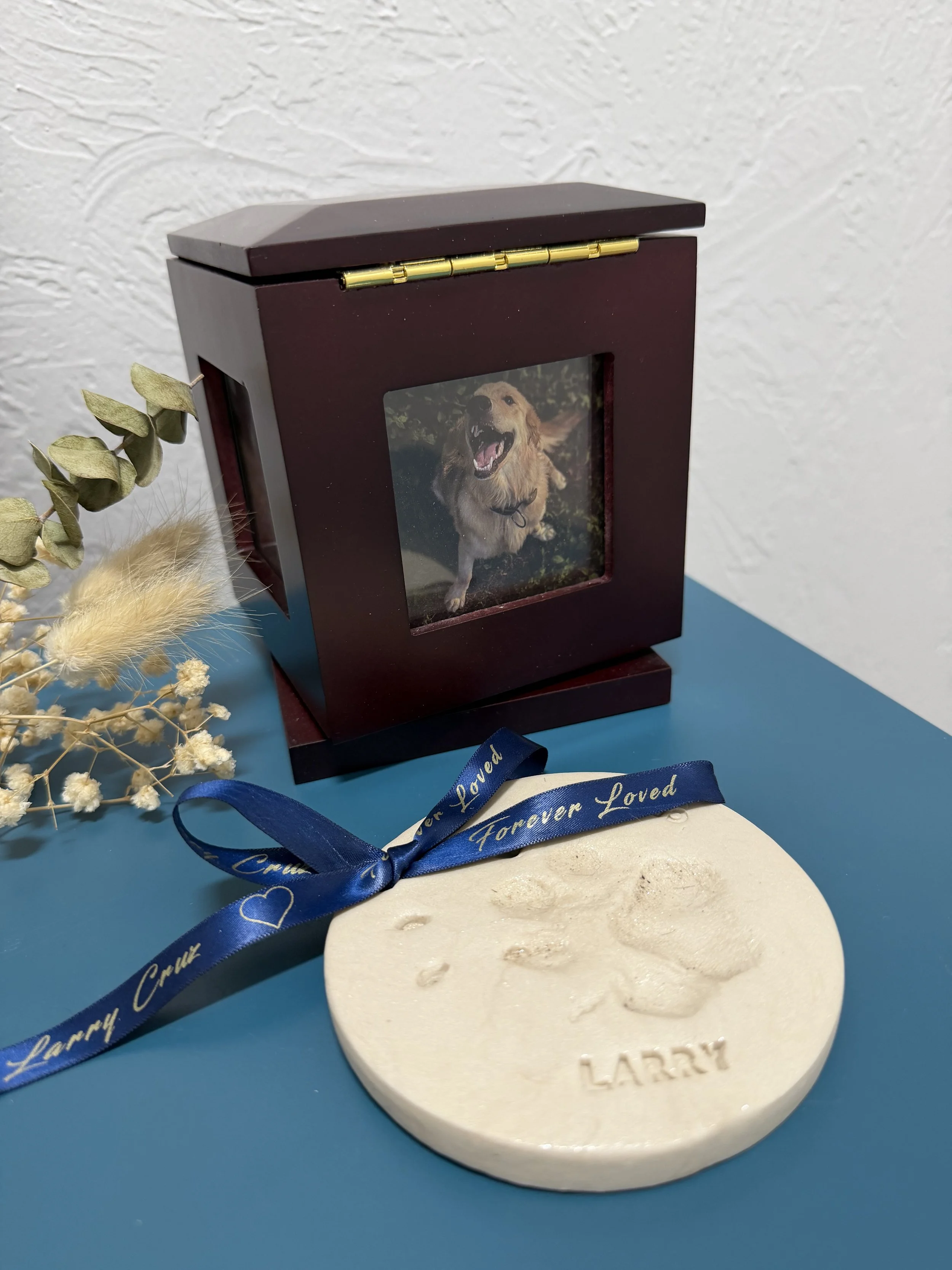 Multi-photo cube and a clay pawprint with an custom ribbon in blue