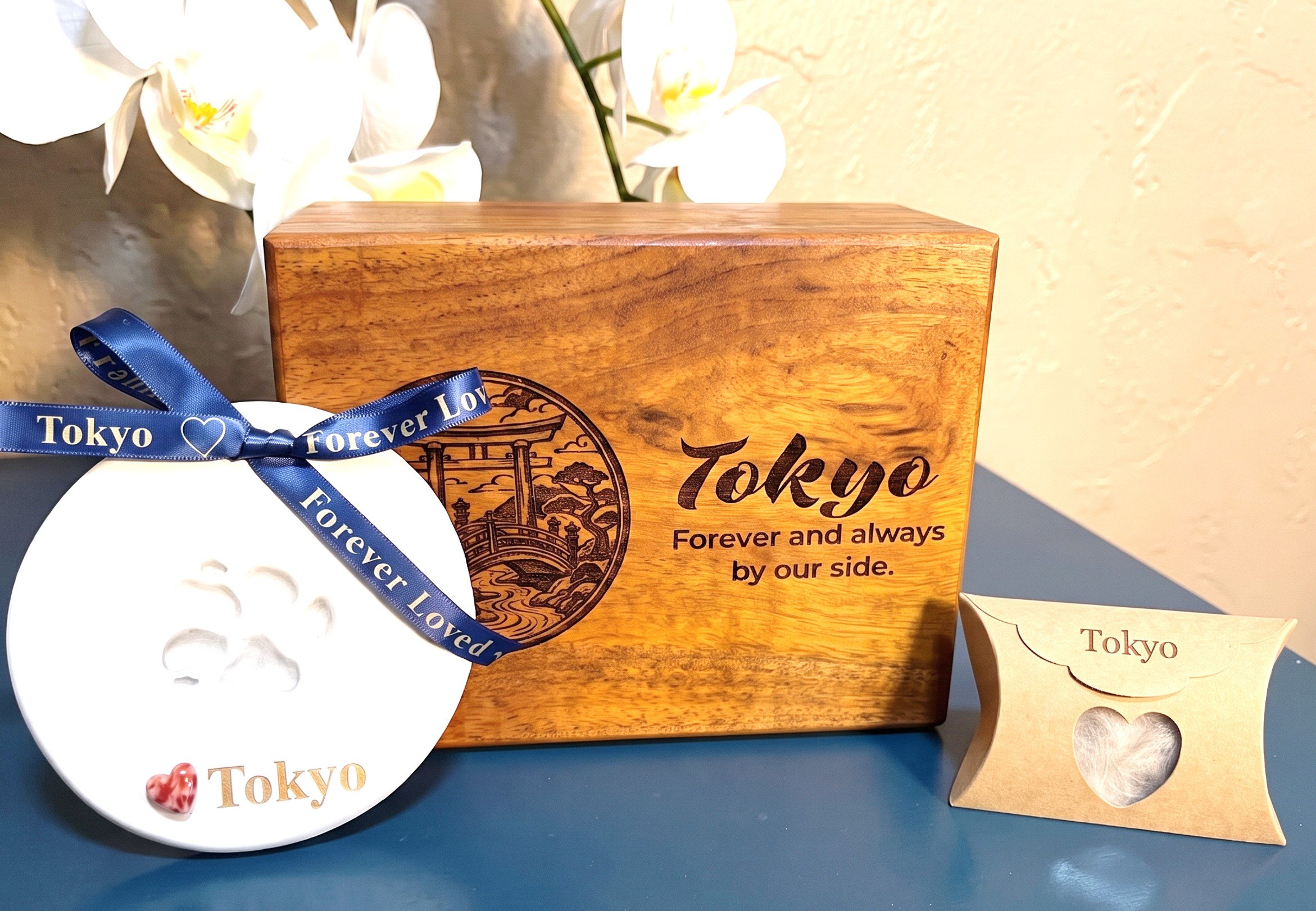 Photo of the acacia wood urn with custom engraving, paw print and fur clipping that is part of the standard private pet aquamation service