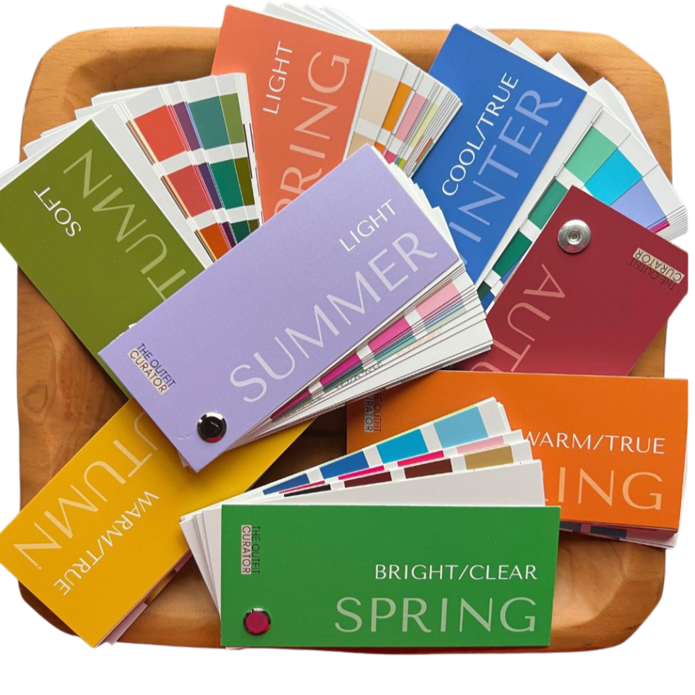 A wooden tray holding color samples for different seasons and temperature types, including summer light, cool/true winter, warm/true summer, bright/clear spring, and warm/true autumn.