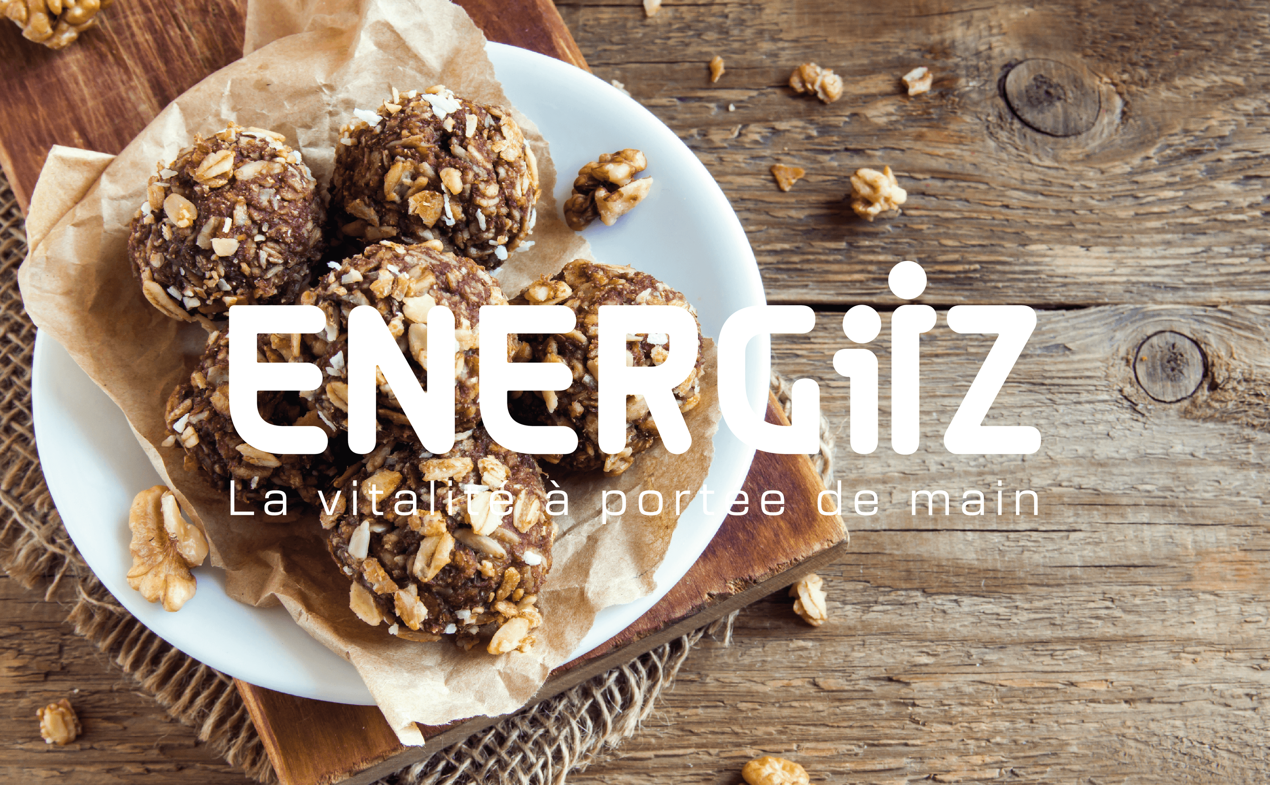 Boules d'énergie aux noix et chocolat sur une assiette blanche avec un fond en bois