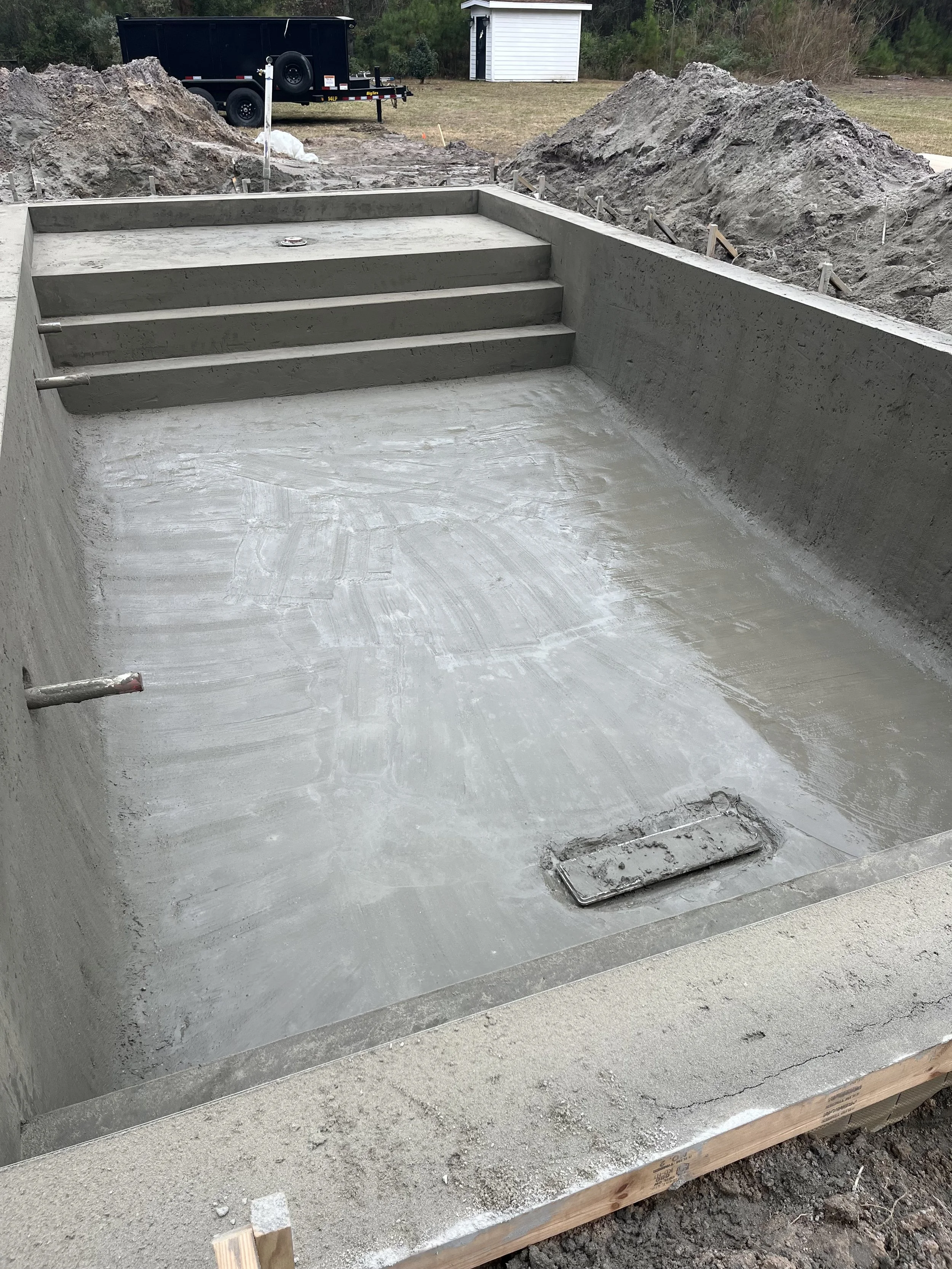 Concrete swimming pool under construction with stairs in Kingsland Georgia.