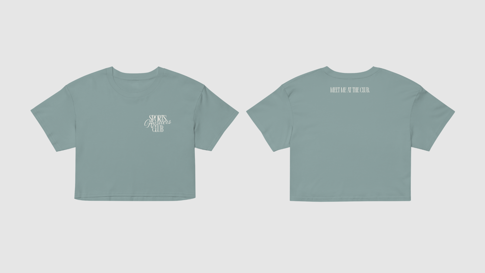 Muted sage green cropped t-shirt with a small “Sports Hustlers Club” logo on the chest and “Meet Me at the Club.” text printed across the upper back.