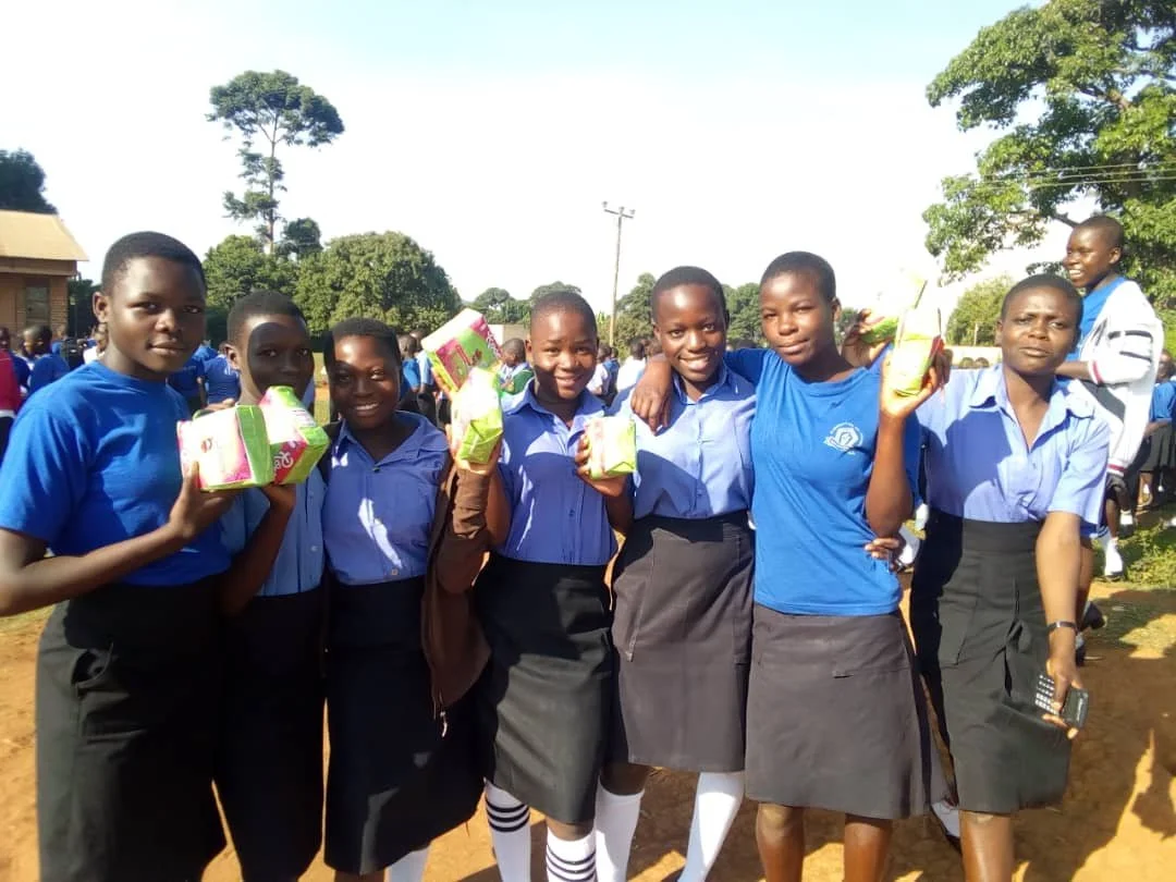 GIVING OUT SANITARY PAD.jpg