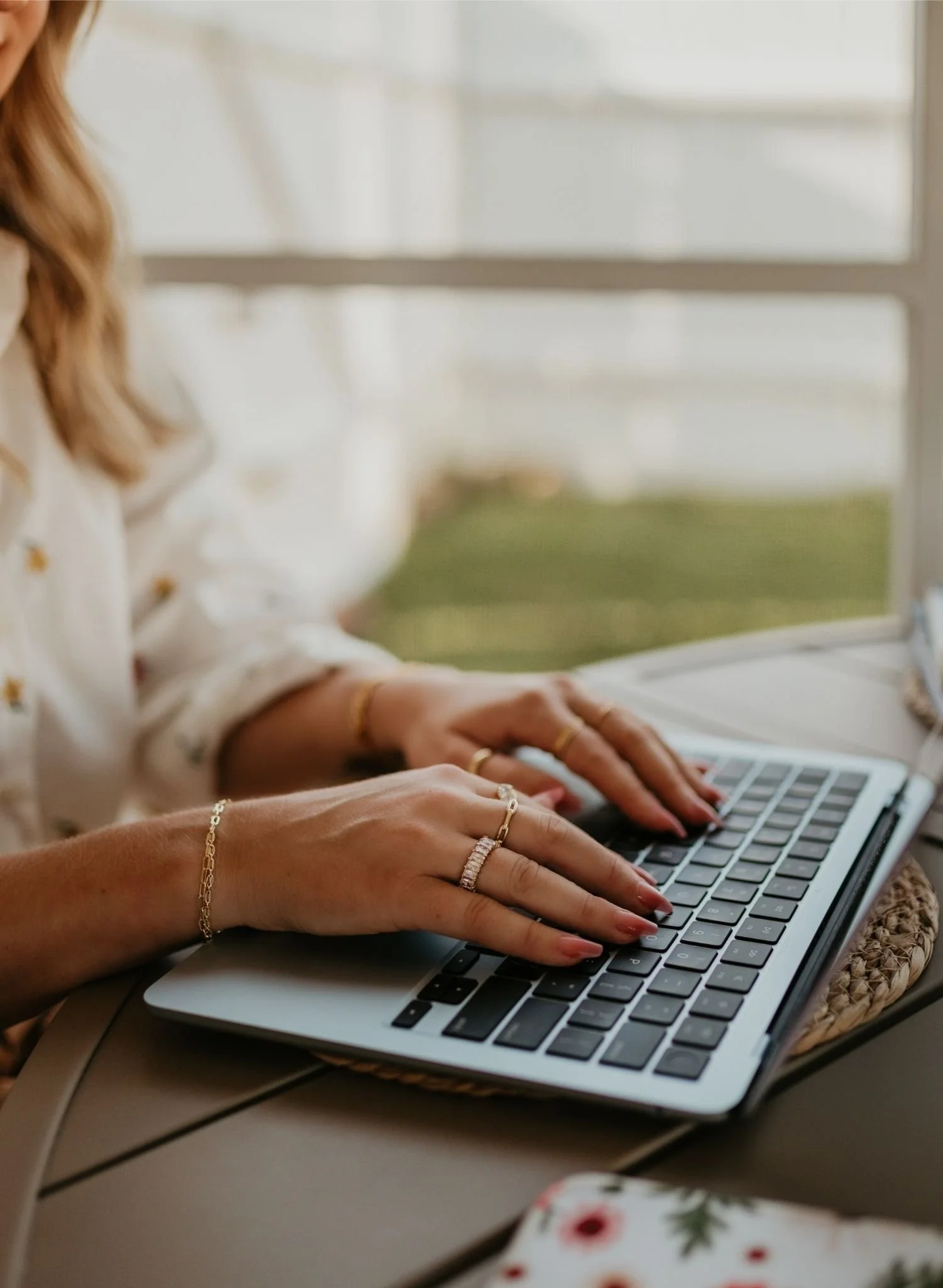 Close up of hands working on a laptop.