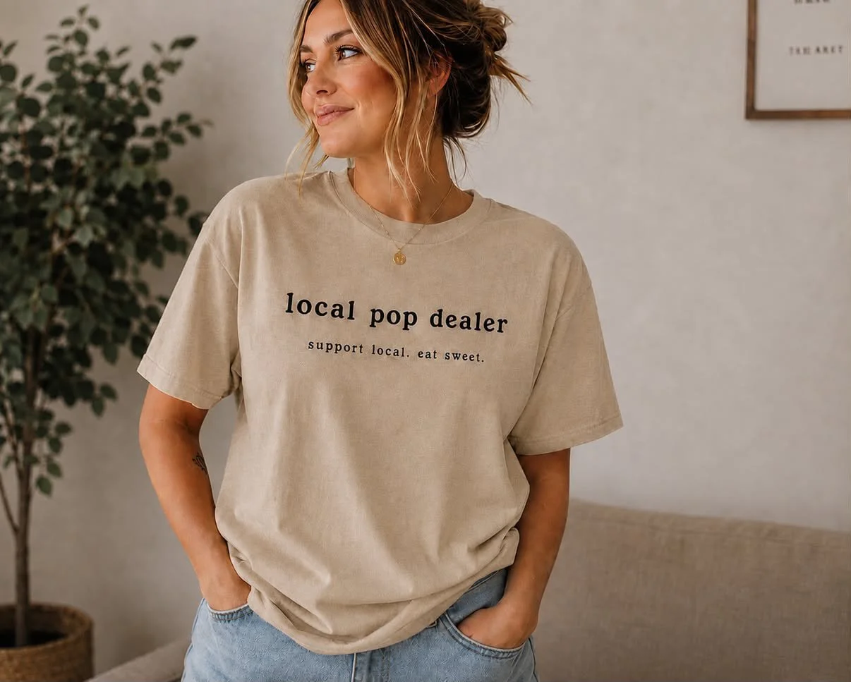 A woman wearing a Lauren's Sweeties t shirt from the Online merch store created by studio hill media.
