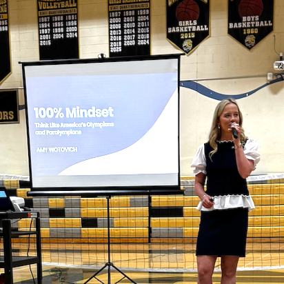 Amy Wotovich giving a motivational keynote speech inspired by her interviews with 200+ Olympians and Paralympians, psychology-backed research, and personal experience as an athlete at Harvard.