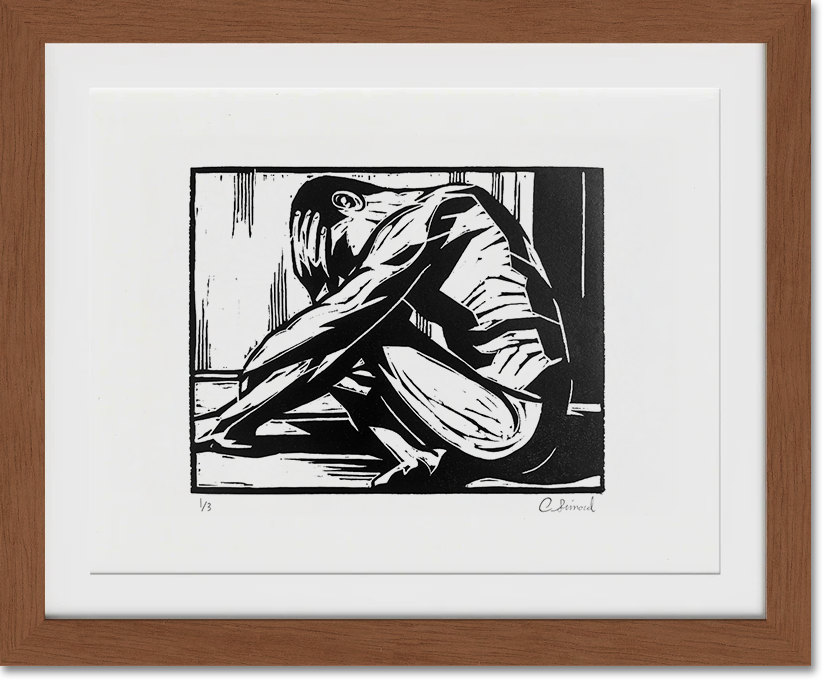 Black and white framed artwork of a nude man sitting with her arms crossed over her knees, in a contemplative pose.