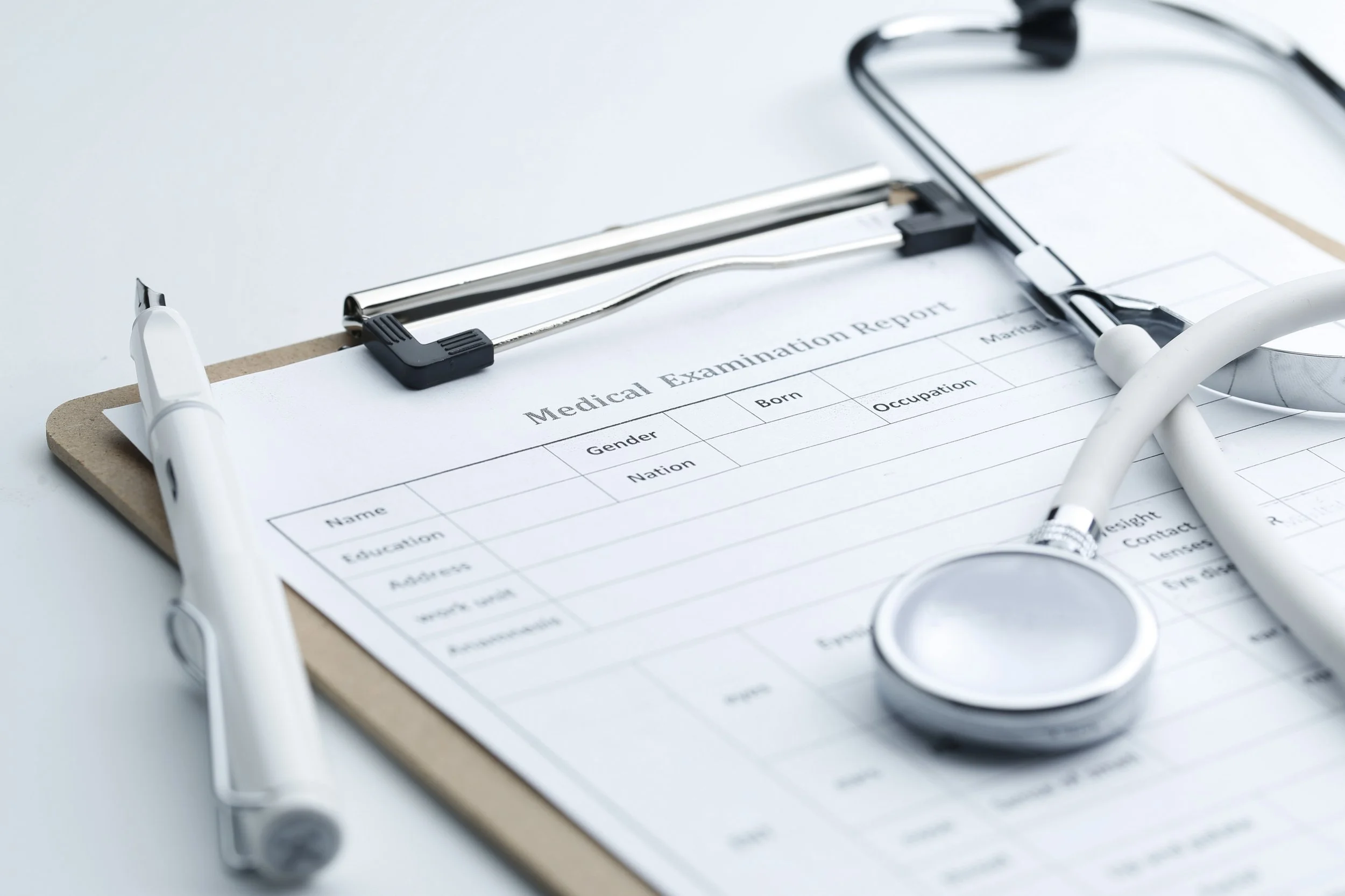 Medical examination report and stethoscope representing OASIS coding and QA review for home health agencies