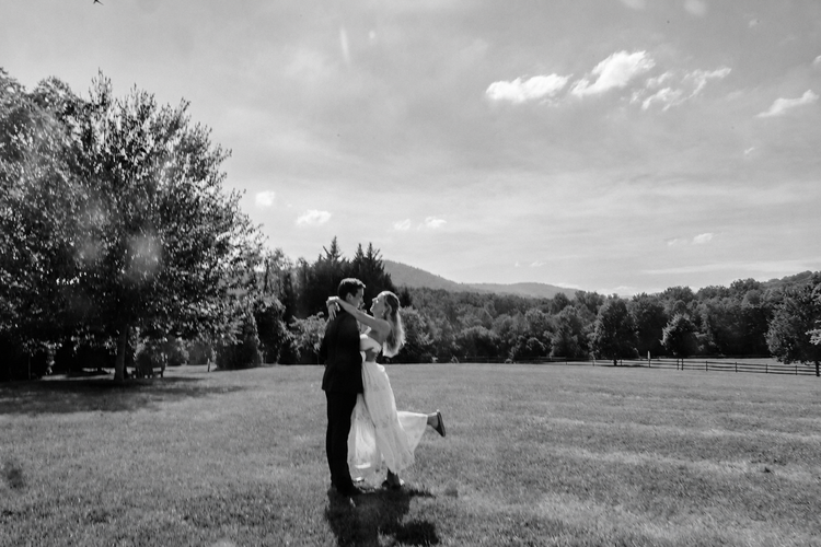 Bride and groom laughing together in a garden