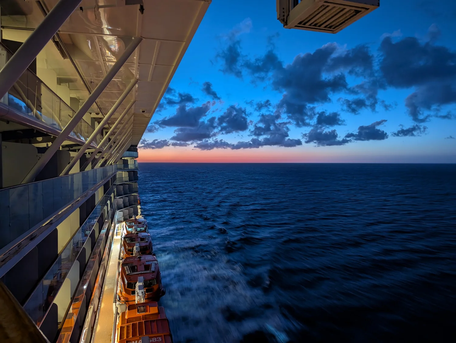 Sunset over the ocean from a cruise ship balcony