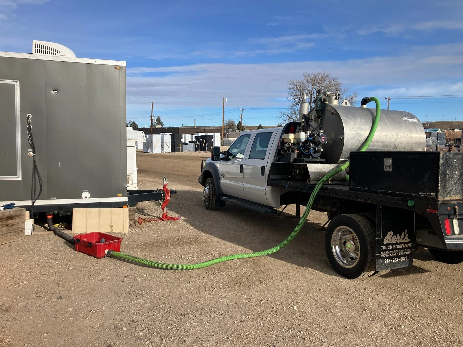 Service truck is hooked up the a luxury restroom trailer.