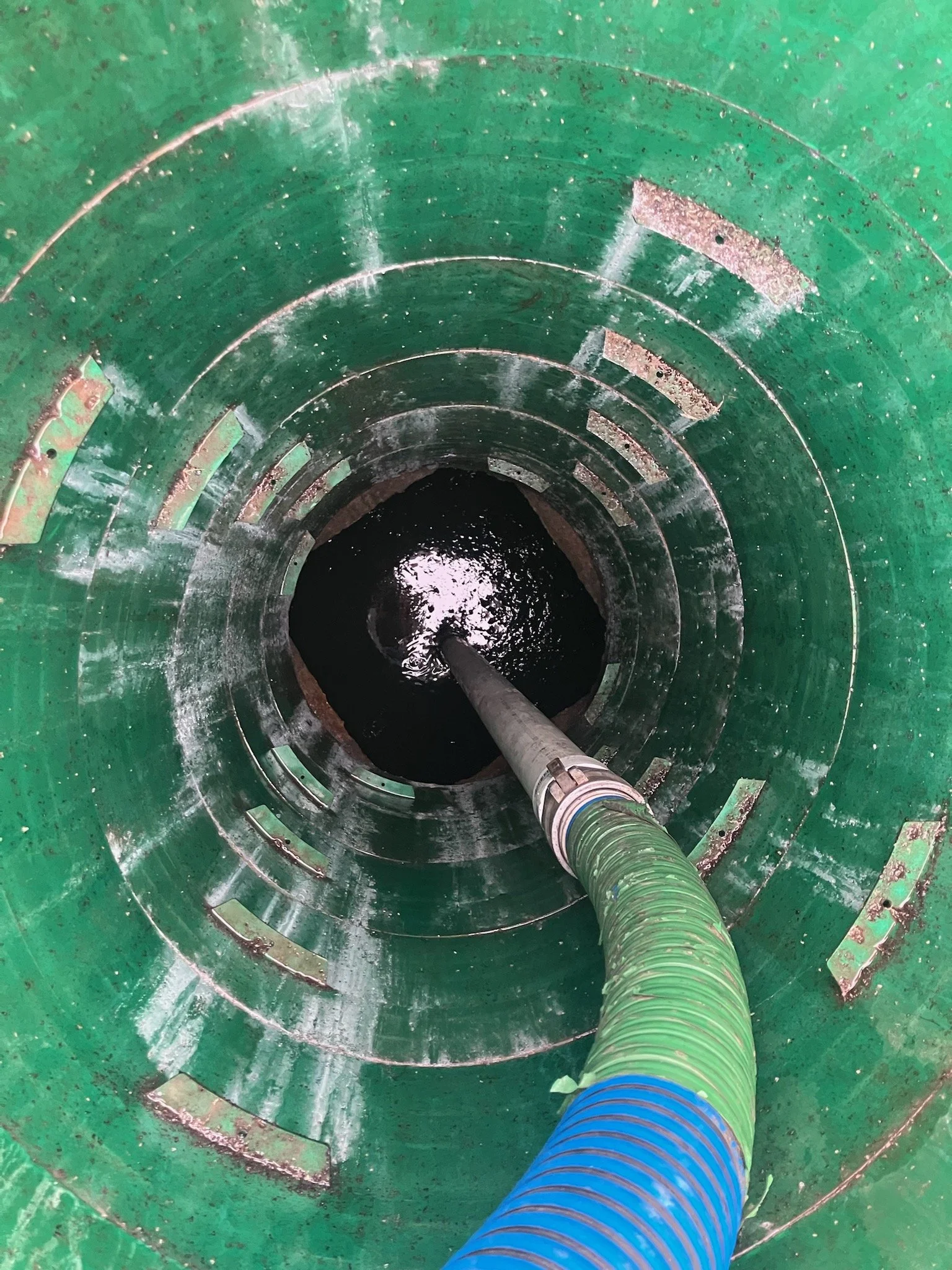 Pump hose dropped into tank being pumped out