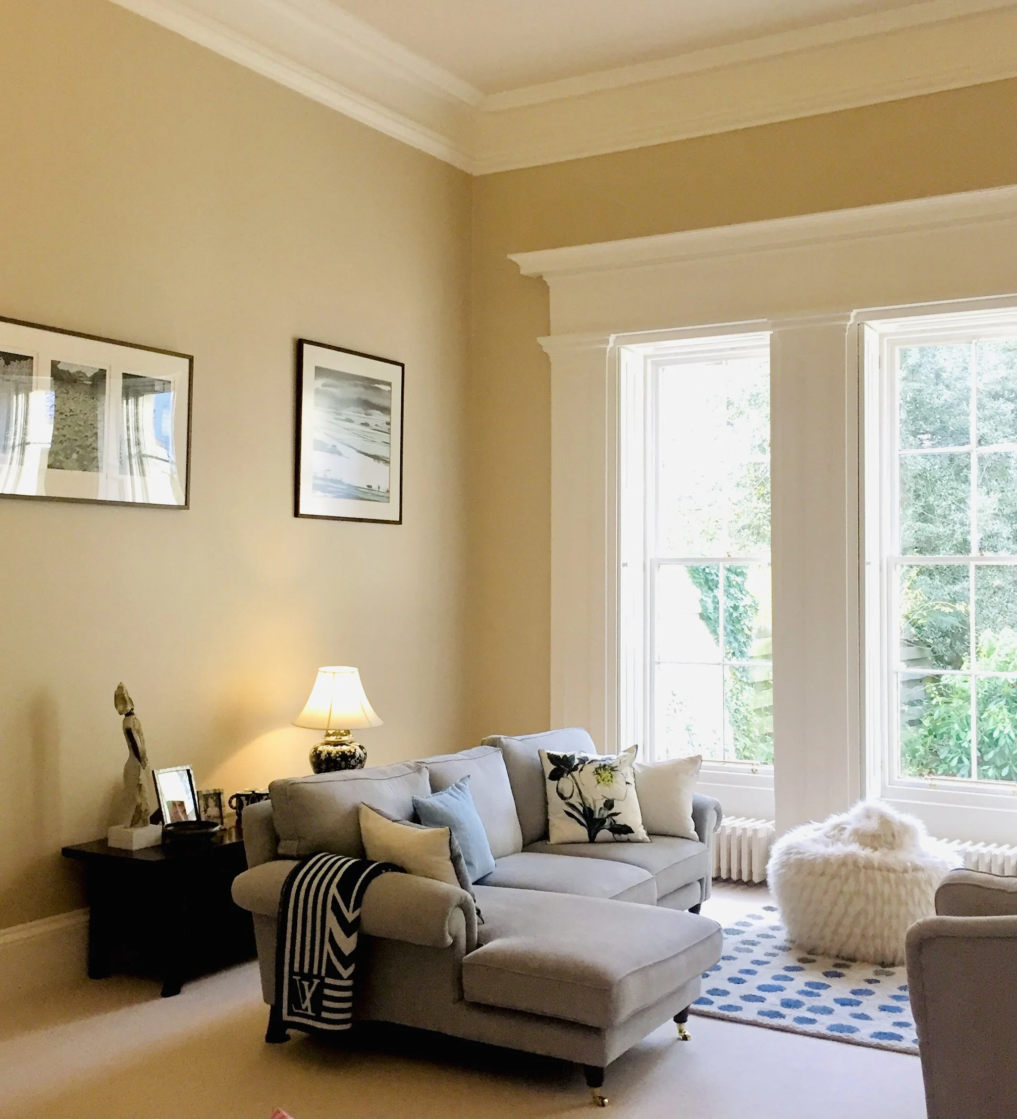 Color swatches, fabric samples, and ceramic pieces arranged on a wooden surface, likely for interior design or decorating purposes.