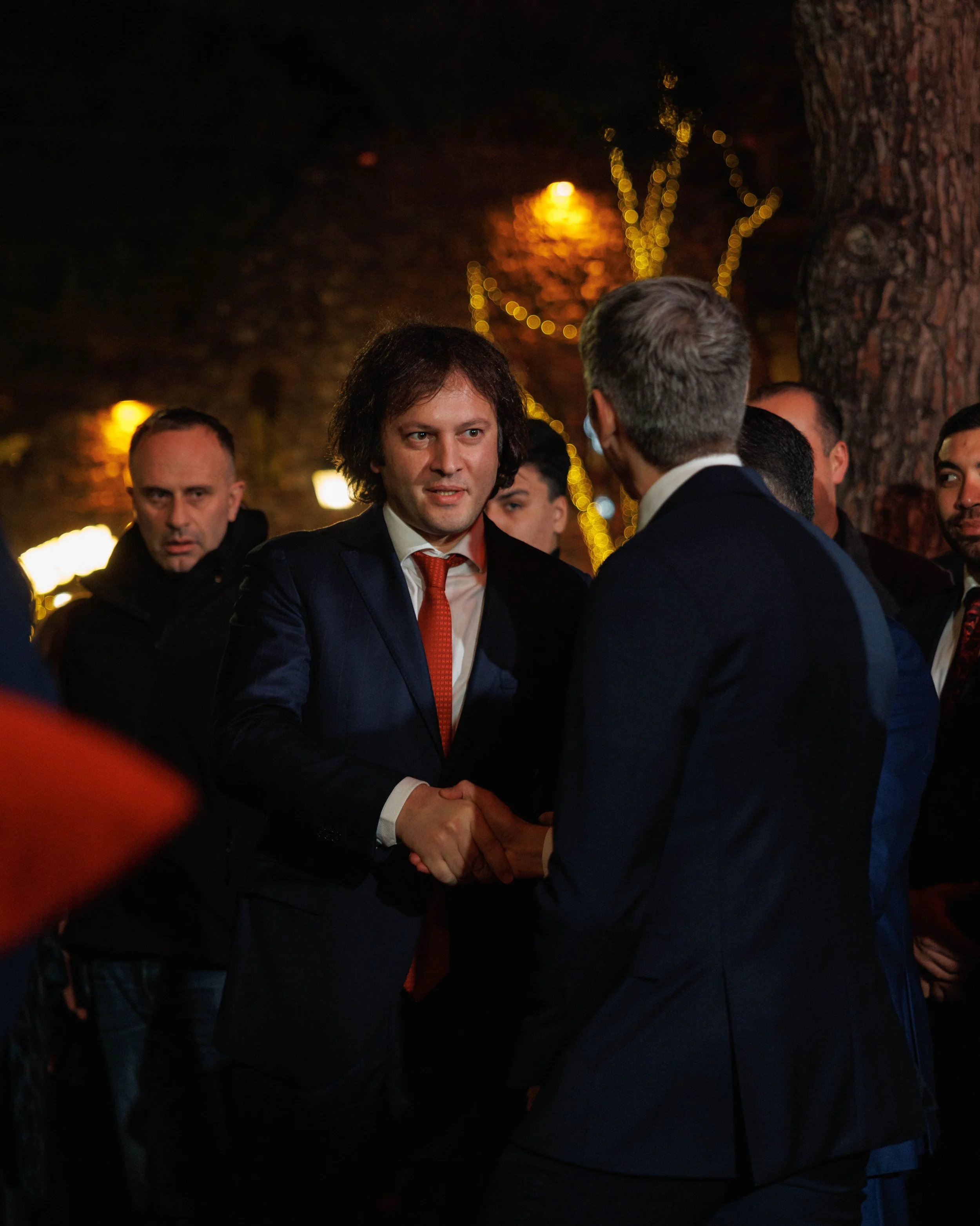 Modern showroom with a car engine on display, an office desk with a chair, and automotive fabric samples on the wall