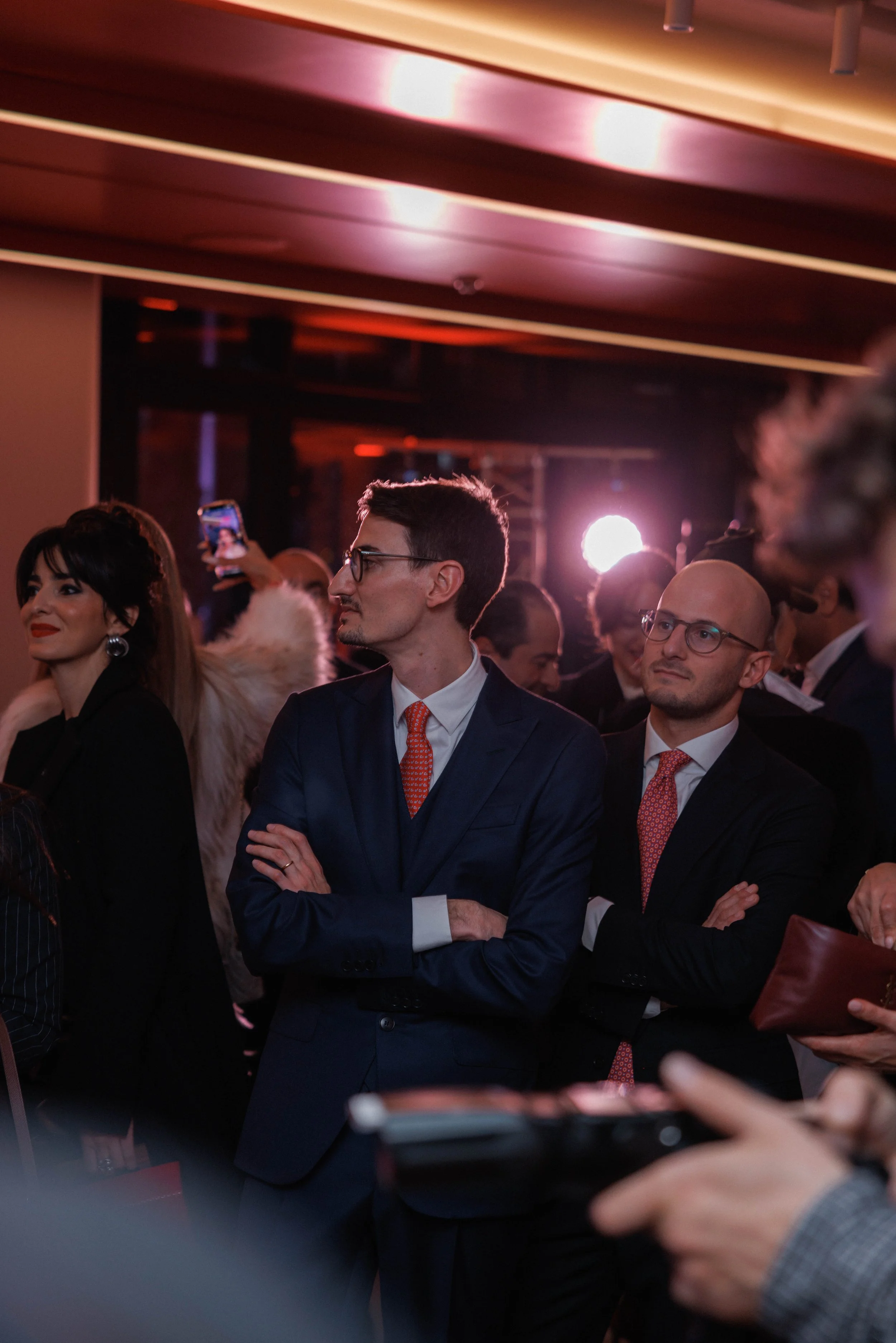 Top view of a blue sports car with its engine visible through rear glass, featuring carbon fiber components and the Bugatti logo.