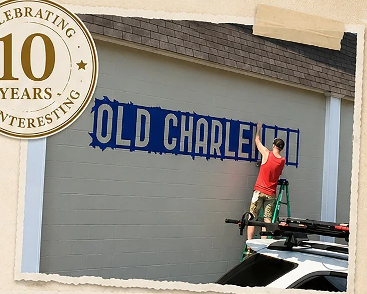 The Old Charleston Trading Company exterior sign being painted during the store's early days.
