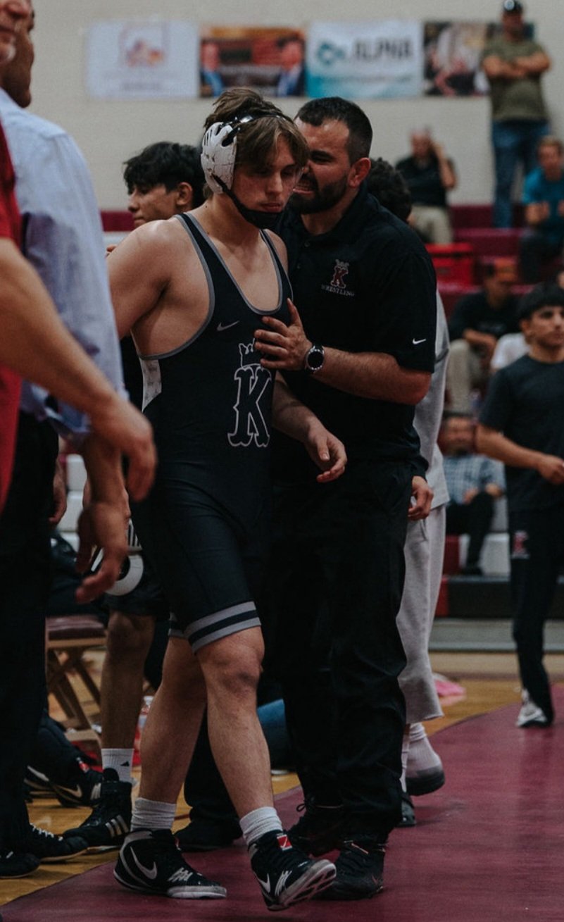 Matador Wrestling Club coach working with a wrestler