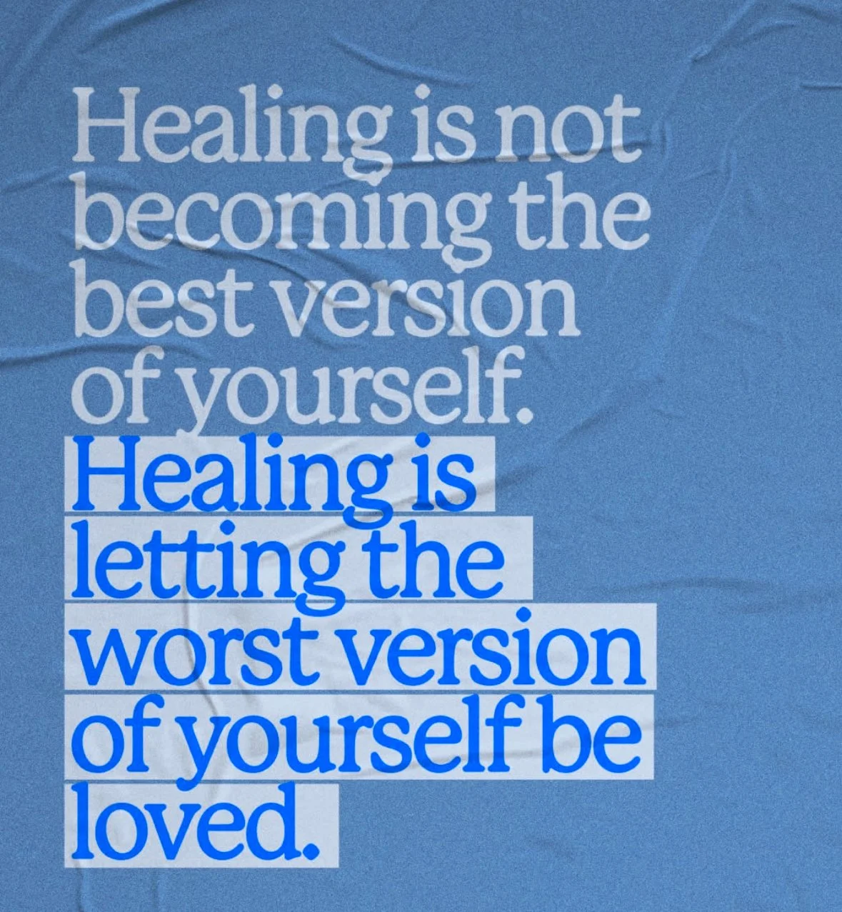 A printed quote on a wrinkled blue background reads: "Healing is not becoming the best version of yourself. Healing is letting the worst version of yourself be loved."