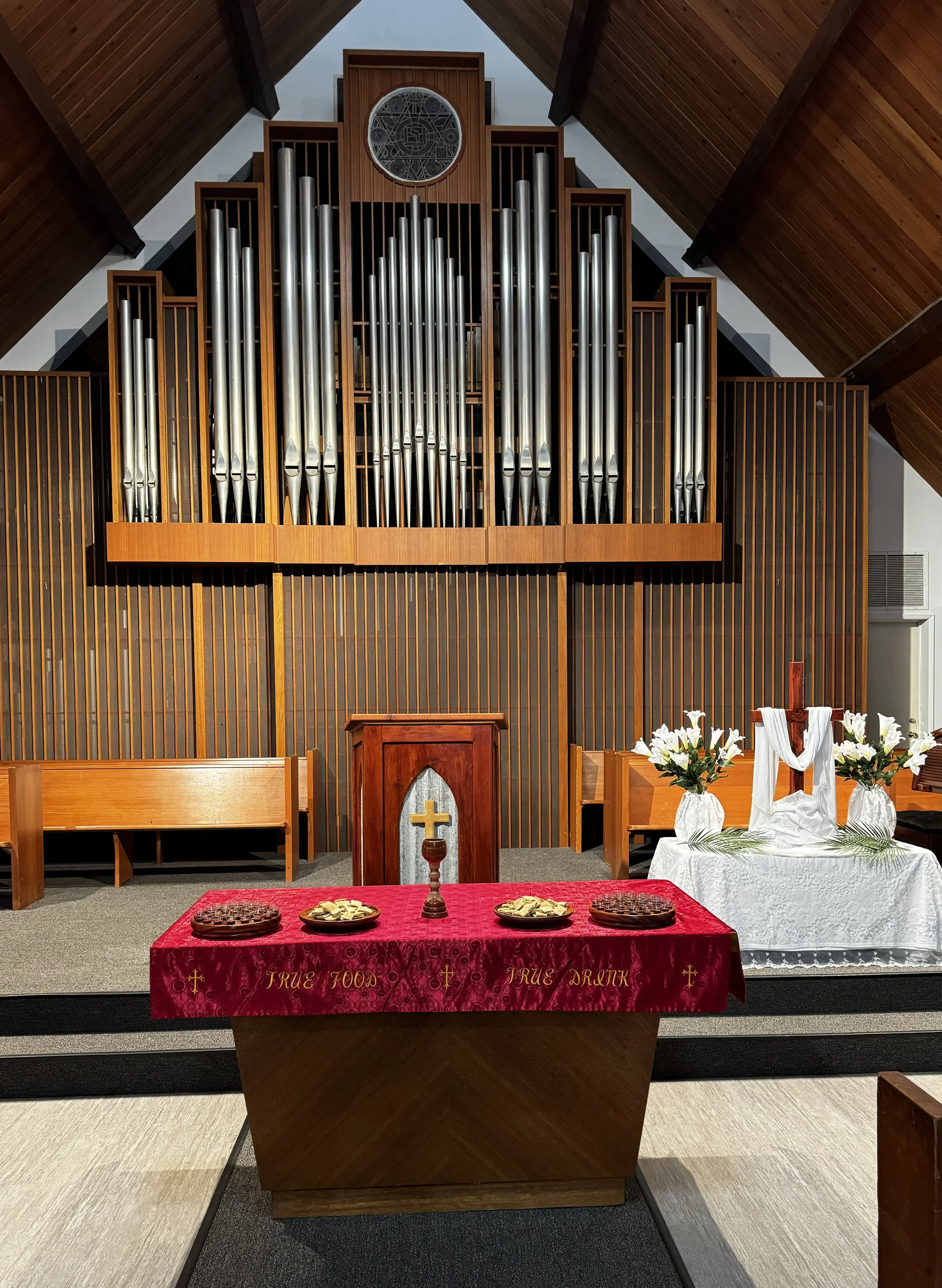 The pulpit and communion table of the Oceanside United Reformed Church decorated for Easter