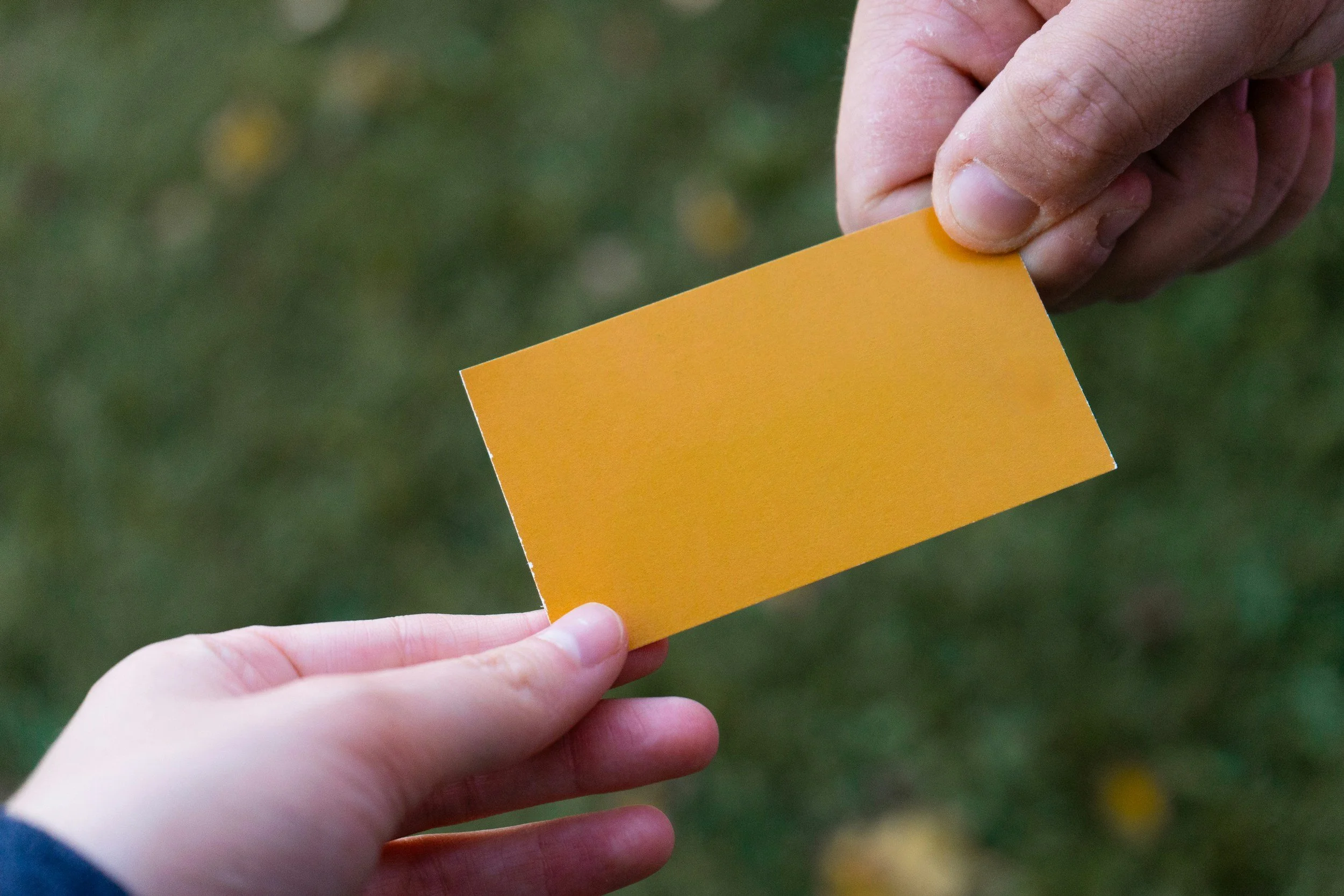 Passing an invitation card to another