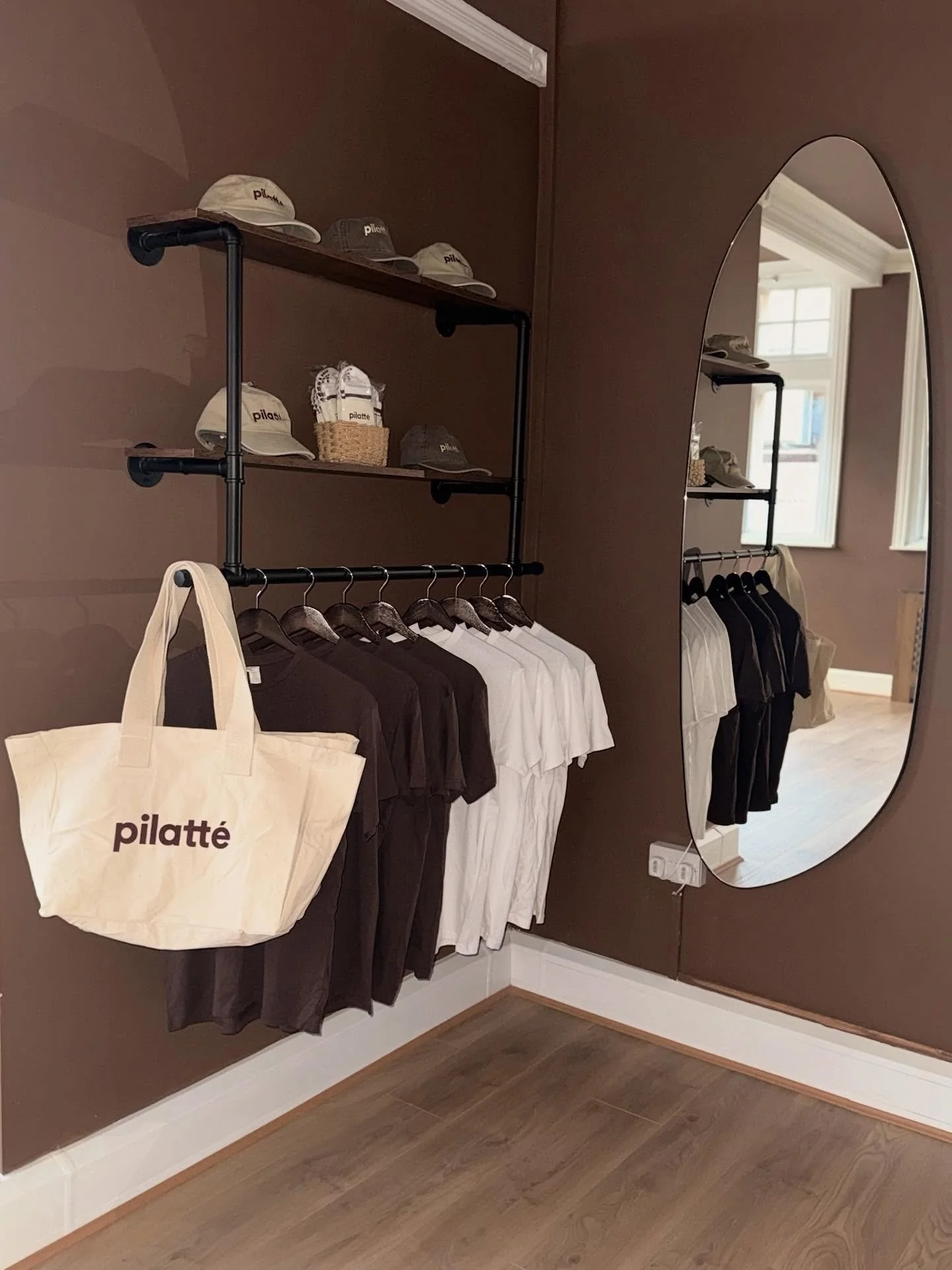 The Merch Wall 🫶🏽✨🤎 so aesthetic it deserves a visit! All available to purchase in studio. Don&rsquo;t forget to sign up for memberships on the App! Link in Bio!